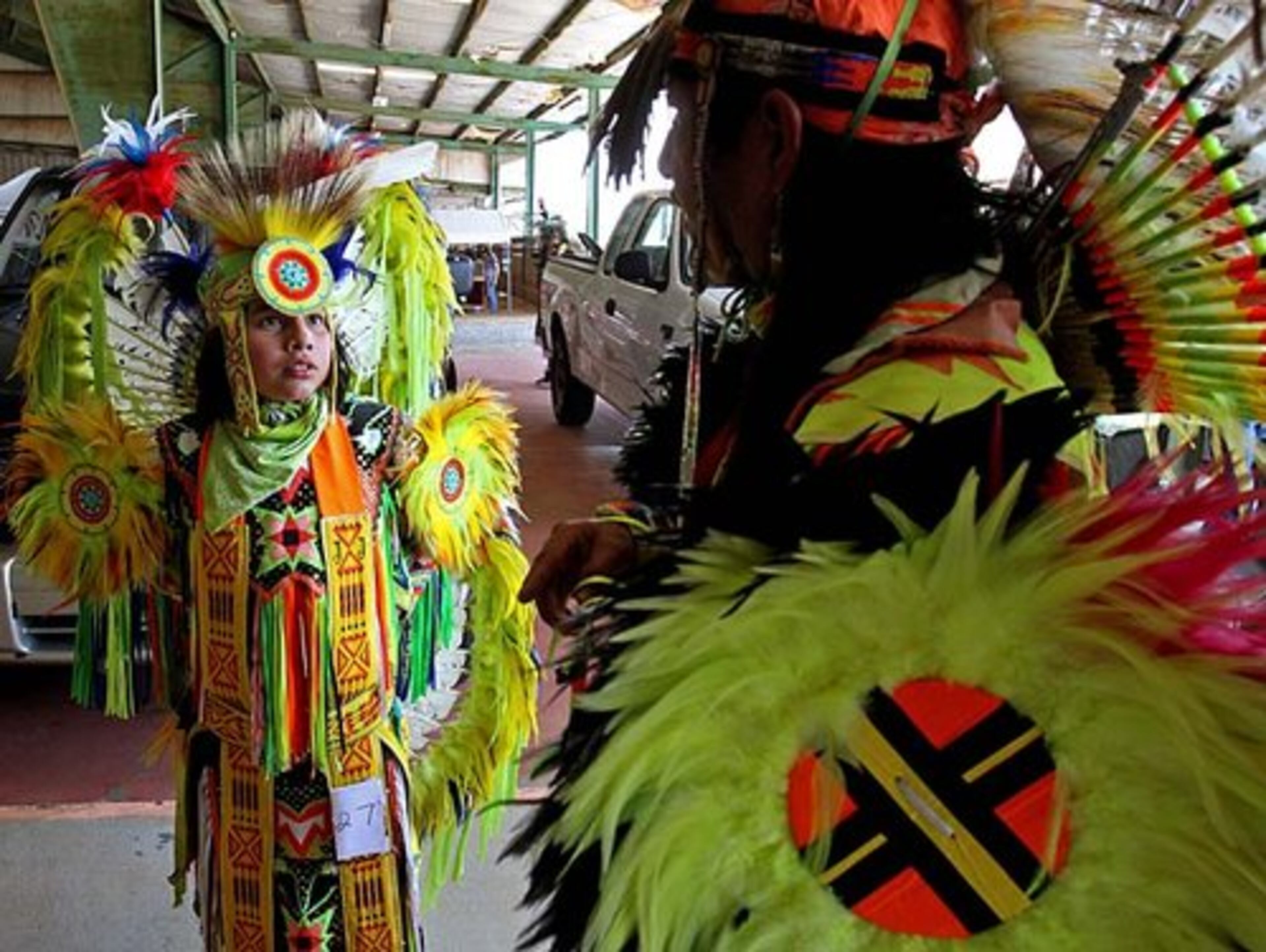 Jonathan Jumper, 12, left, of Kennesaw, talks with his father Robin Jumper as they wait for their performances during the American Indian Festival at the Gwinnett County Fairgrounds Saturday afternoon in Lilburn, Ga., May 26, 2012. The Jumper's are originally from Cherokee, NC., and they are an Eastern Band of Cherokee Indian of the Snowbird Community.