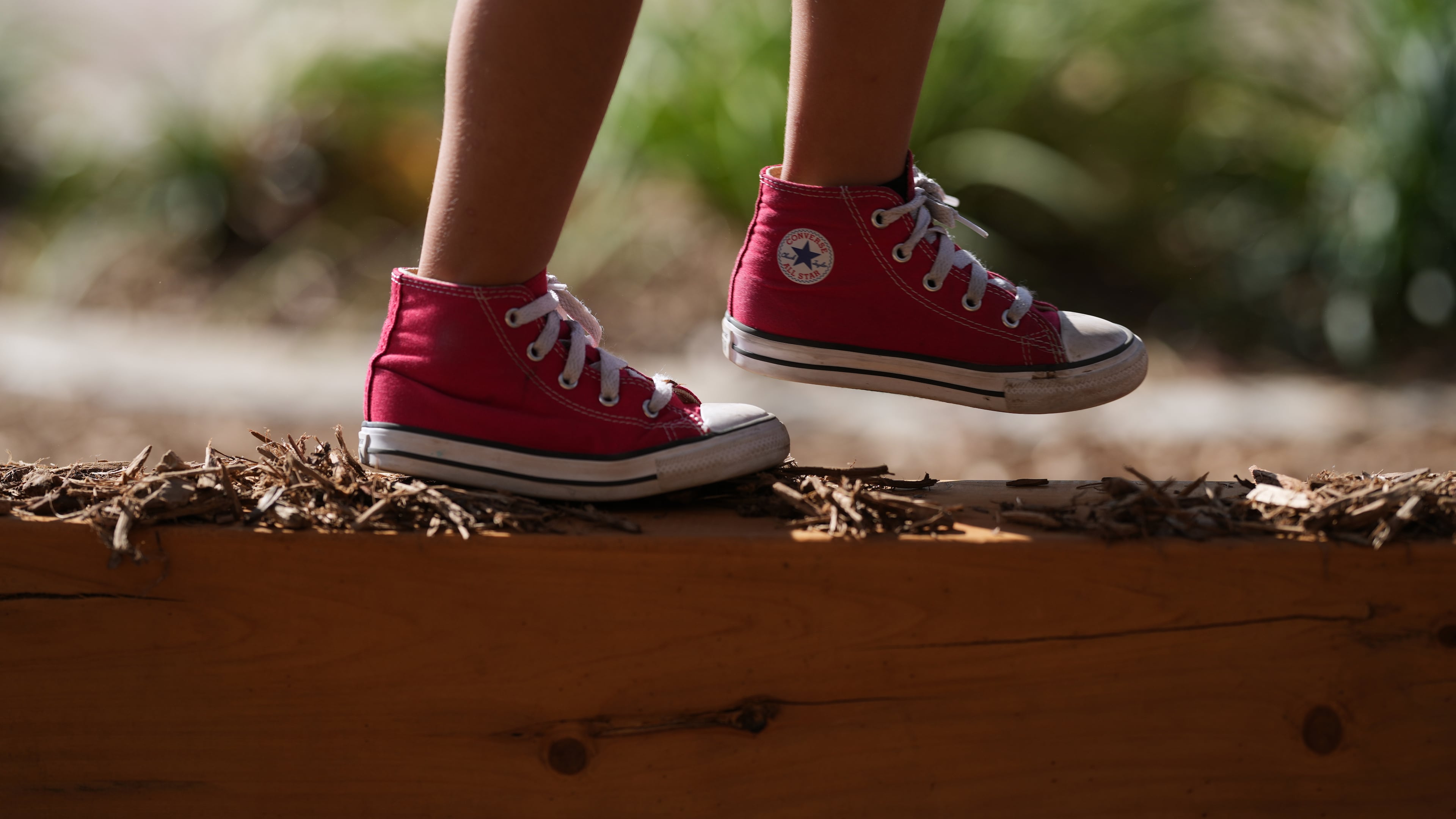 A Pre-K 4 SA student walks a beam on the playground, Oct. 9, 2025, in San Antonio. (AP Photo/Eric Gay)