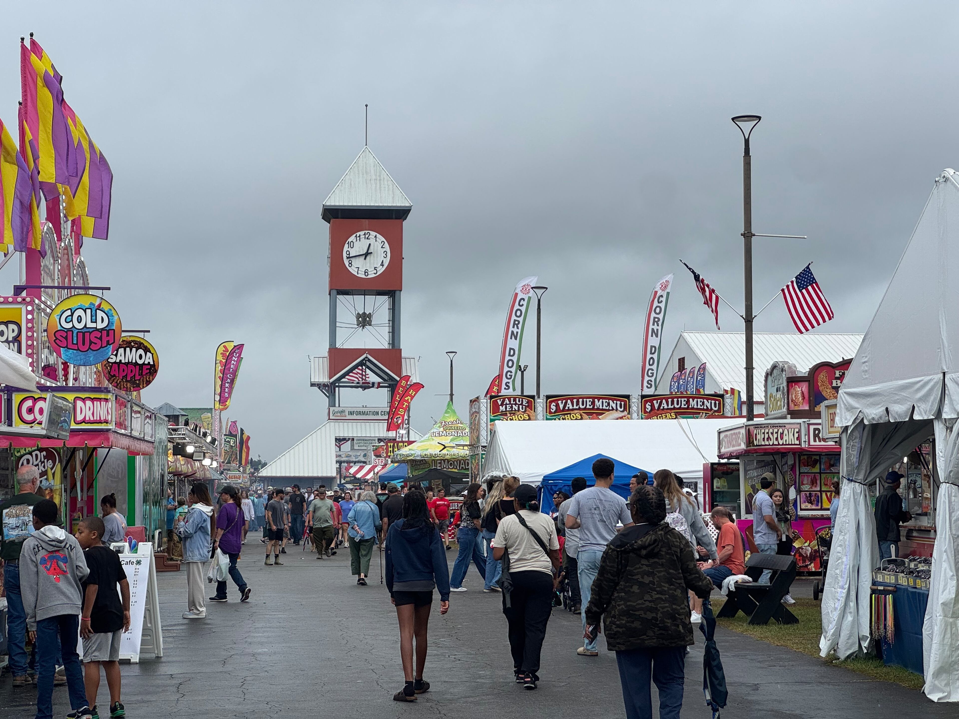 Attendees walk under a gray sky at the Georgia National Fair on Sunday, Oct. 5, 2025. (Caleb Groves/AJC)