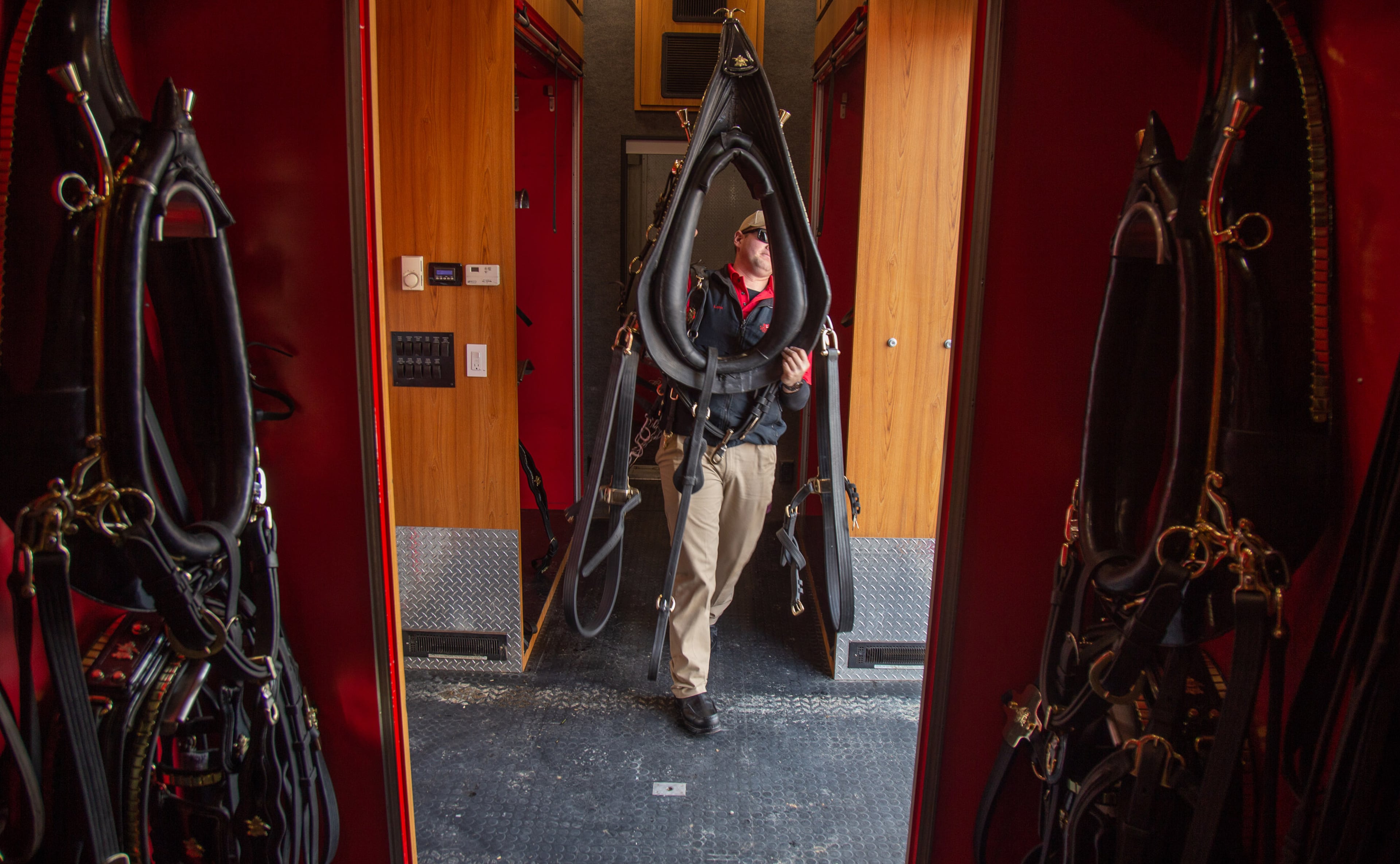 Budweiser Clydesdale handler Lane Soendker gets a horses tack to prepare one of the 8 Budweiser Clydesdales to pull a wagon February 01, 2018. in Buckhead. STEVE SCHAEFER / SPECIAL TO THE AJC