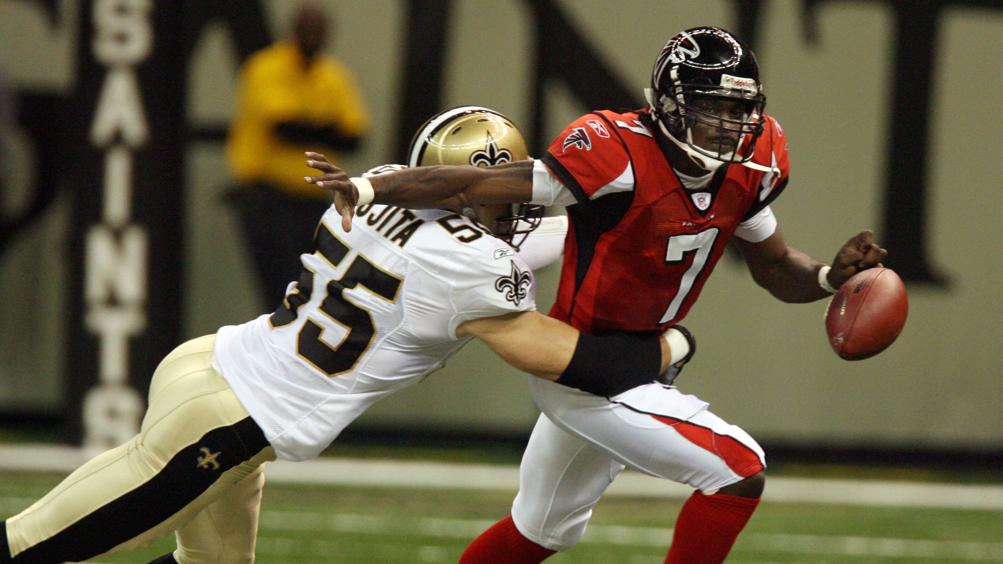 060925 - NEW ORLEANS, LA -- Falcons quarterback Mike Vick (7) fumbles the ball under pressure from Saints Scott Fujita (55) which leads to a New Orleans touchdown on the opening drive in the first quarter of the Falcons at Saints NFL game to reopen the New Orleans Superdome on Monday, Sept. 25, 2006. (Curtis Compton / AJC staff)