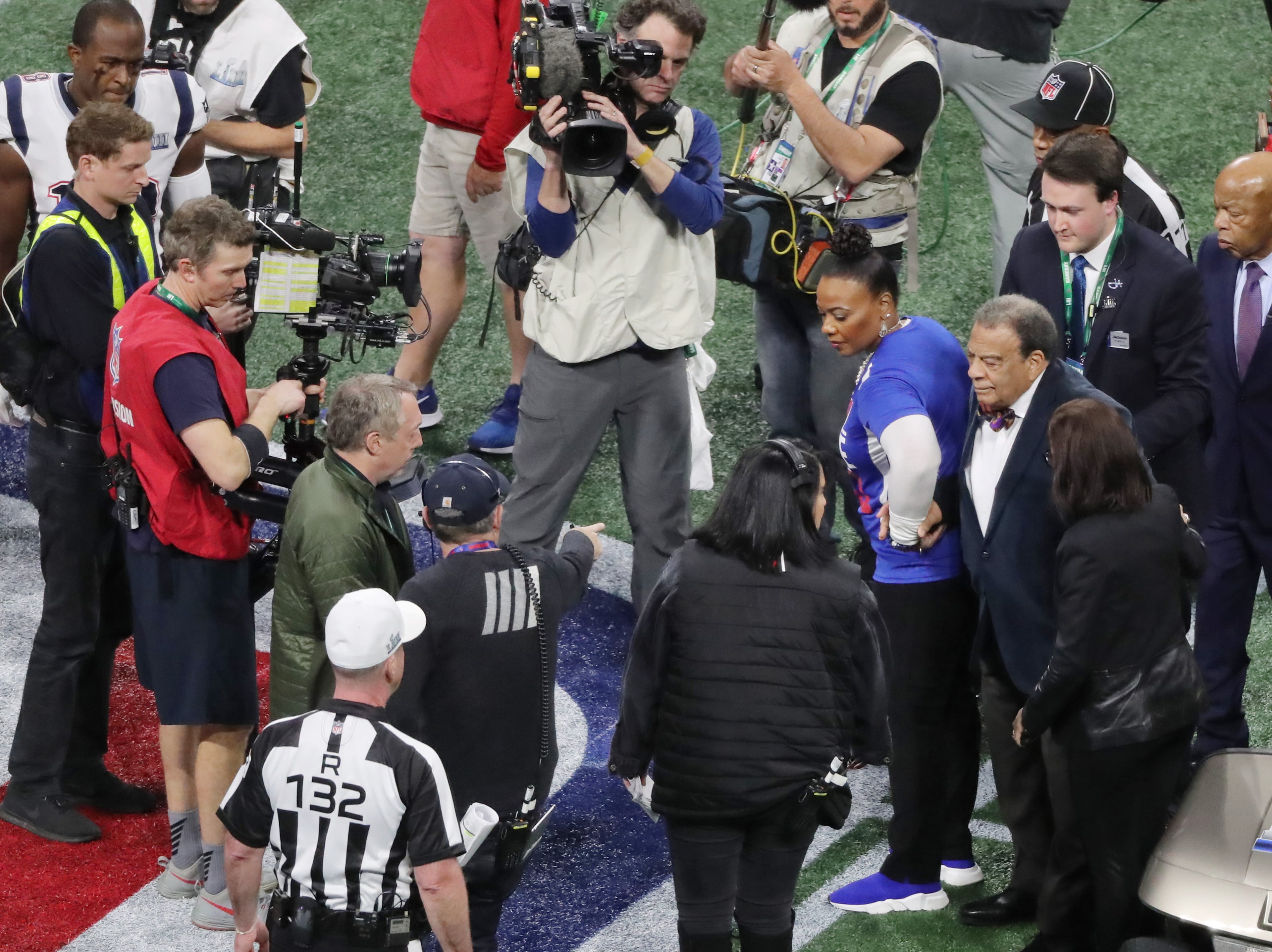 Bernice King, in blue jersey at right, stands next to Andrew Young on the field before the New England Patriots played the Los Angeles Rams in Super Bowl LIII on Sunday, Feb. 3, 2019 at Mercedes-Benz Stadium in Atlanta, Ga. (JOHN SPINK/JSPINK@AJC.COM)