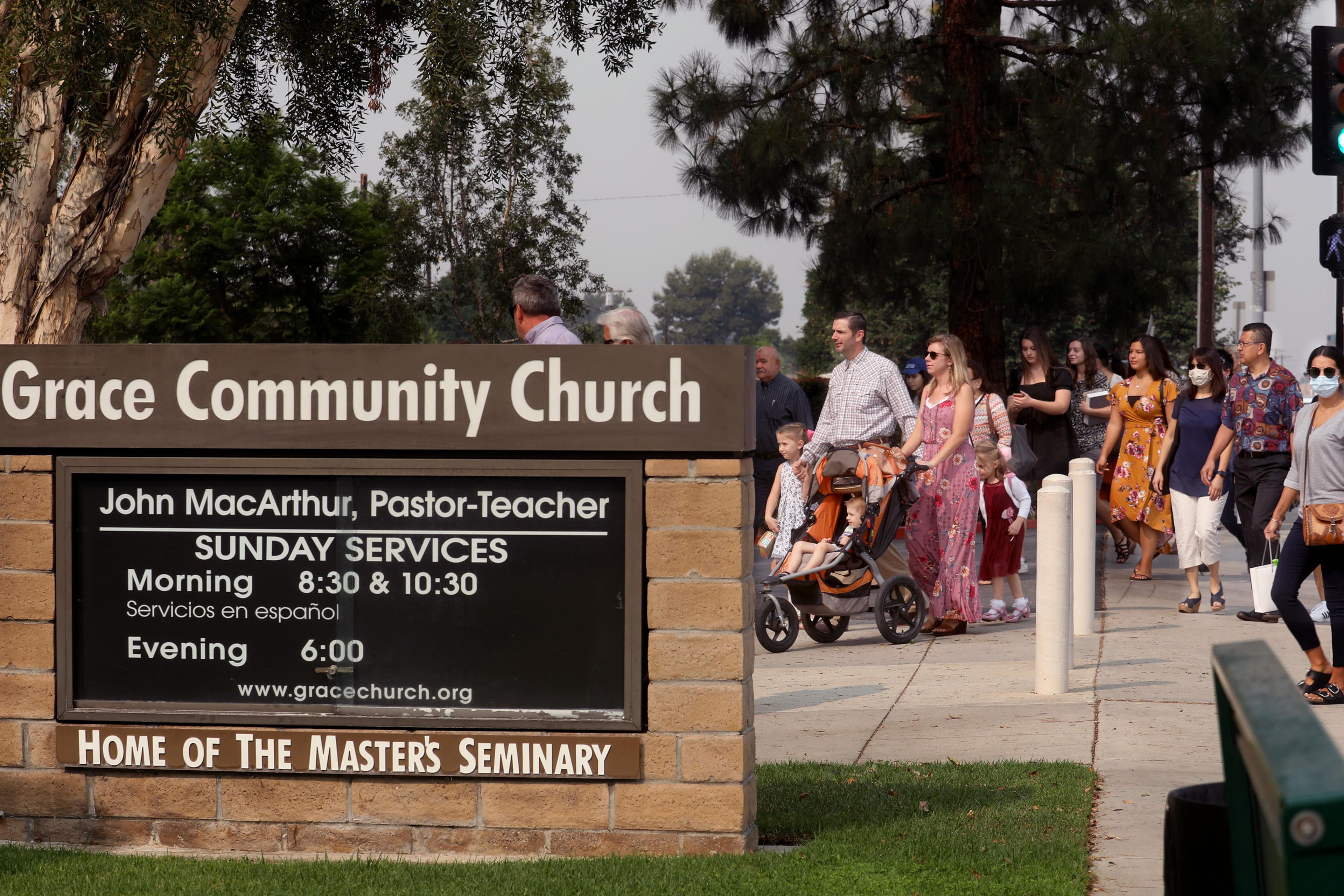 Grace Community Church parishioners make their way to Sunday service in Sun Valley, California, on September 13, 2020. The church held a packed morning service, defying a court order directing them to refrain from holding indoor services due to the COVID-19 pandemic. (Genaro Molina/Los Angeles Times/TNS)