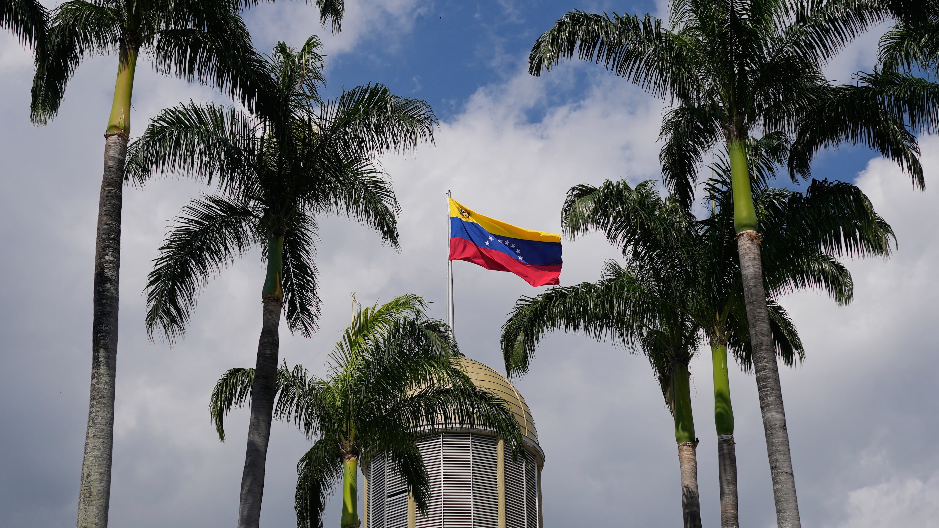 FILE - A Venezuelan flag waves in the wind atop the National Assembly palace in Caracas, Venezuela, Jan. 20, 2026. (AP Photo/Matias Delacroix, File)