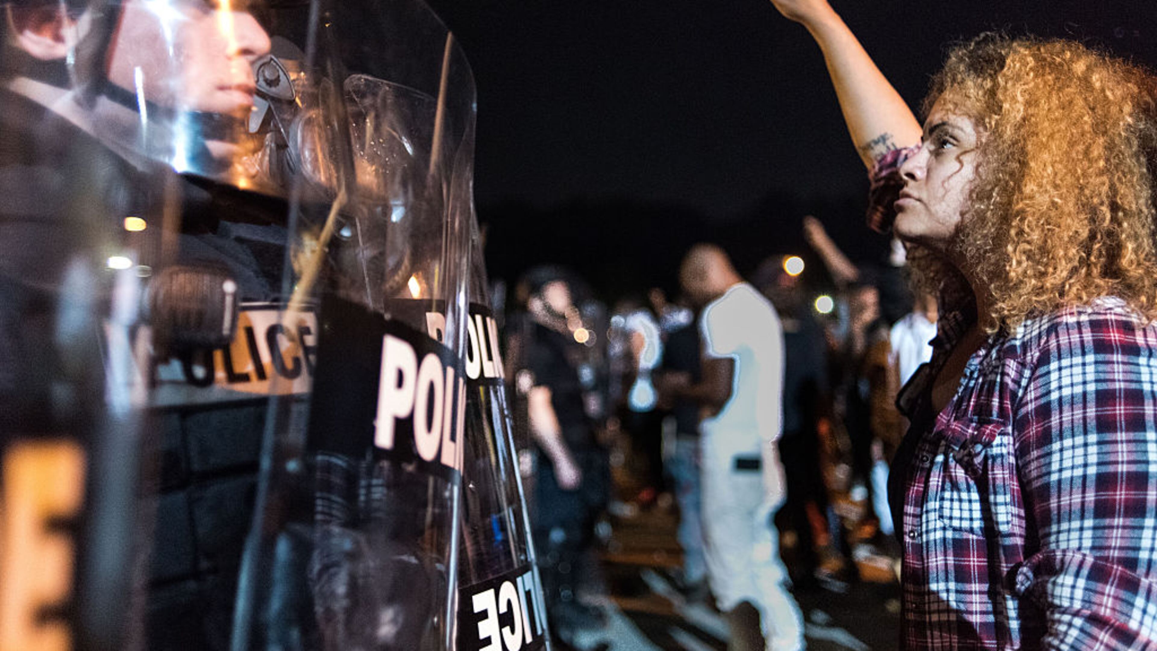 CHARLOTTE, NC – SEPTEMBER 21: Police officers face off with protestors on the I-85 (Interstate 85) during protests following the death of a man shot by a police officer on September 21, 2016 in Charlotte, NC. The protests began the previous night following the fatal shooting of 43-year-old Keith Lamont Scott at an apartment complex near UNC Charlotte. (Photo by Sean Rayford/Getty Images)