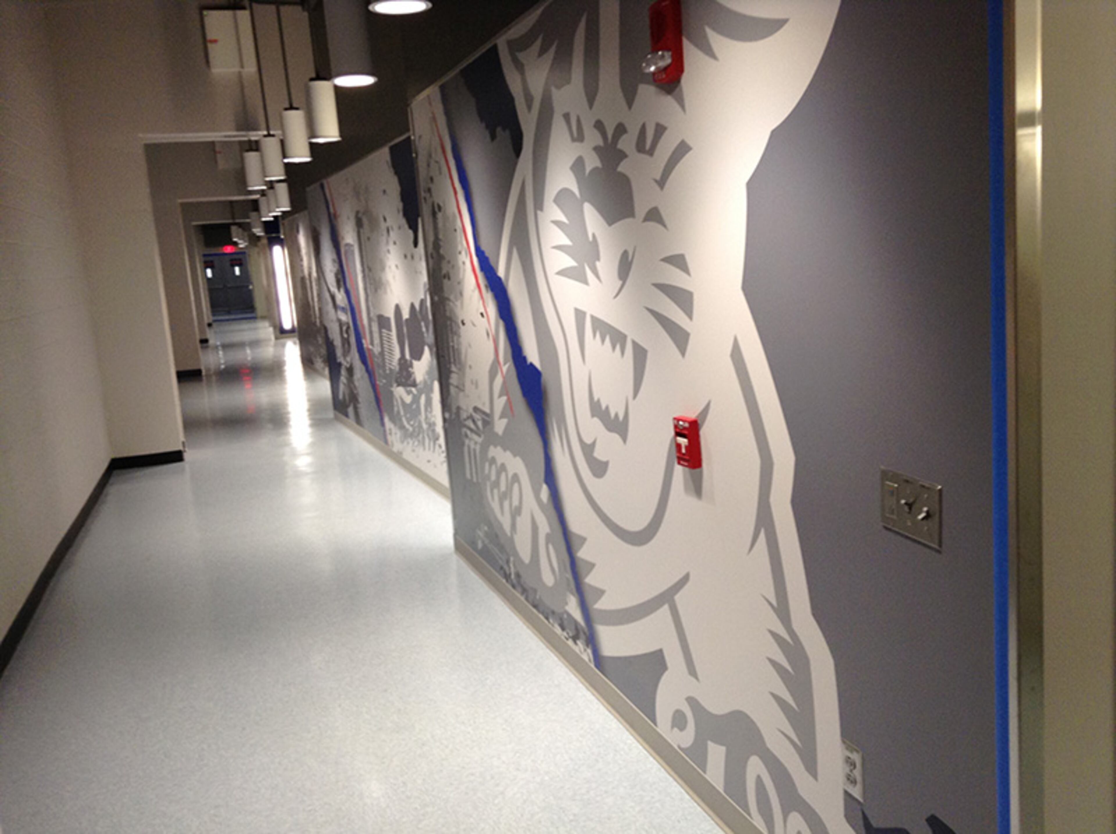 As fans come up the escalators from Decatur Street to the third level of the Sports Arena, the hallway to the locker rooms, which are side-by-side, are on the right.