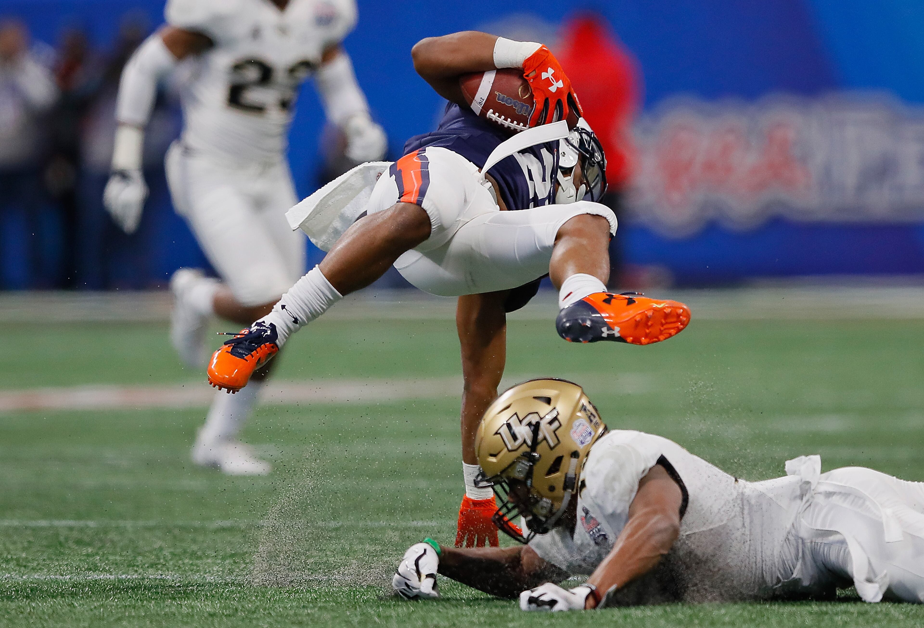 ATLANTA, GA - JANUARY 01: Ryan Davis #23 of the Auburn Tigers is tackled by Mike Hughes #19 of the UCF Knights in the first half during the Chick-fil-A Peach Bowl at Mercedes-Benz Stadium on January 1, 2018 in Atlanta, Georgia. (Photo by Kevin C. Cox/Getty Images)