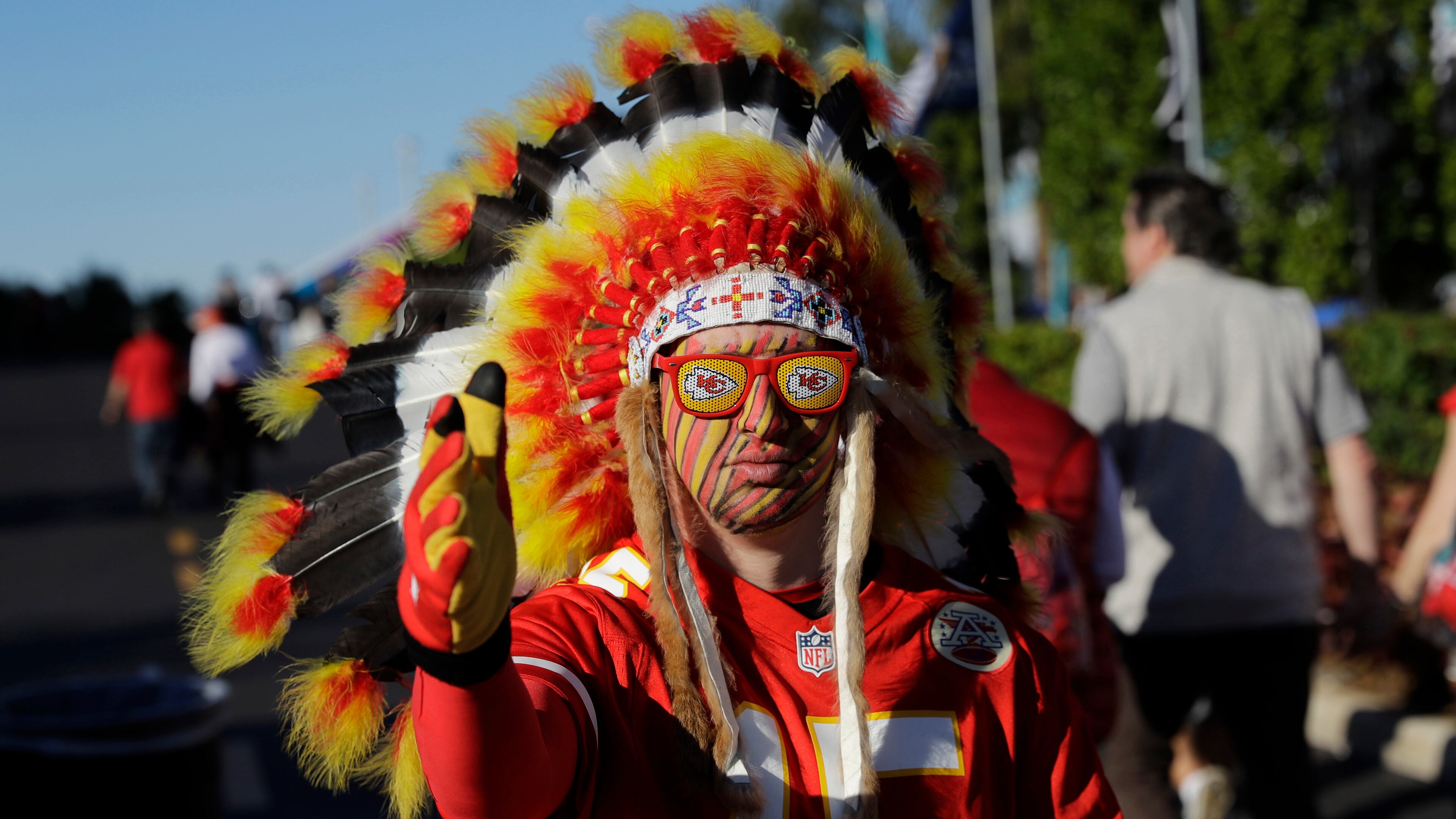 A Kansas City fan walks outside the stadium before Super Bowl 54 Feb. 2, 2020, in Miami Gardens, Fla. The Kansas City Chiefs fans who file into Arrowhead Stadium for the season opener were not allowed to be wearing headdresses or face paint.