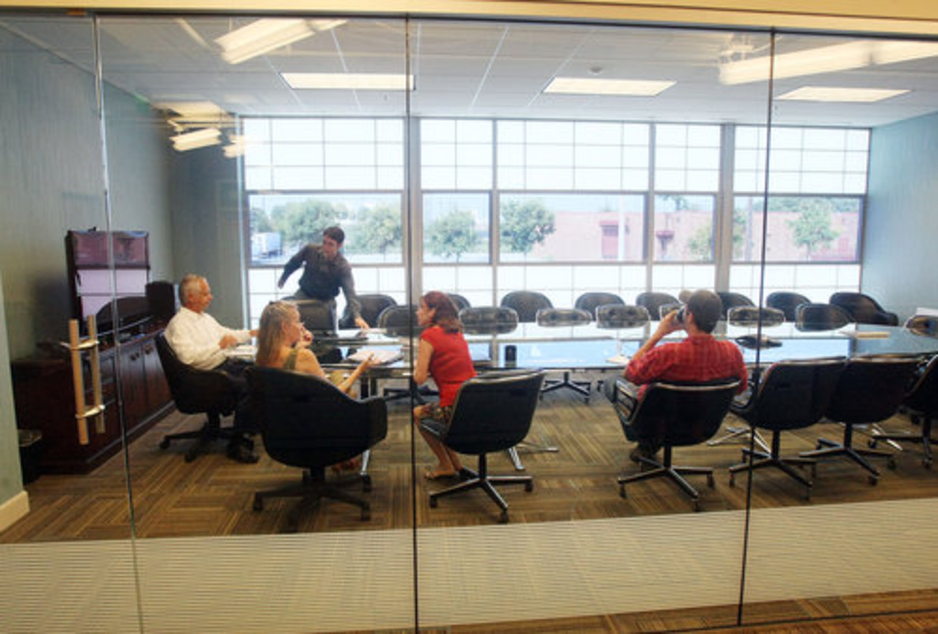 Arthur Jacobus (left), Atlanta Ballet's new executive director, leads a meeting in one of the glassed conference rooms. Jacobus thinks the new facilities will help the company build an identity that is "more physical, more contemporary, more kinetic, more edgy."