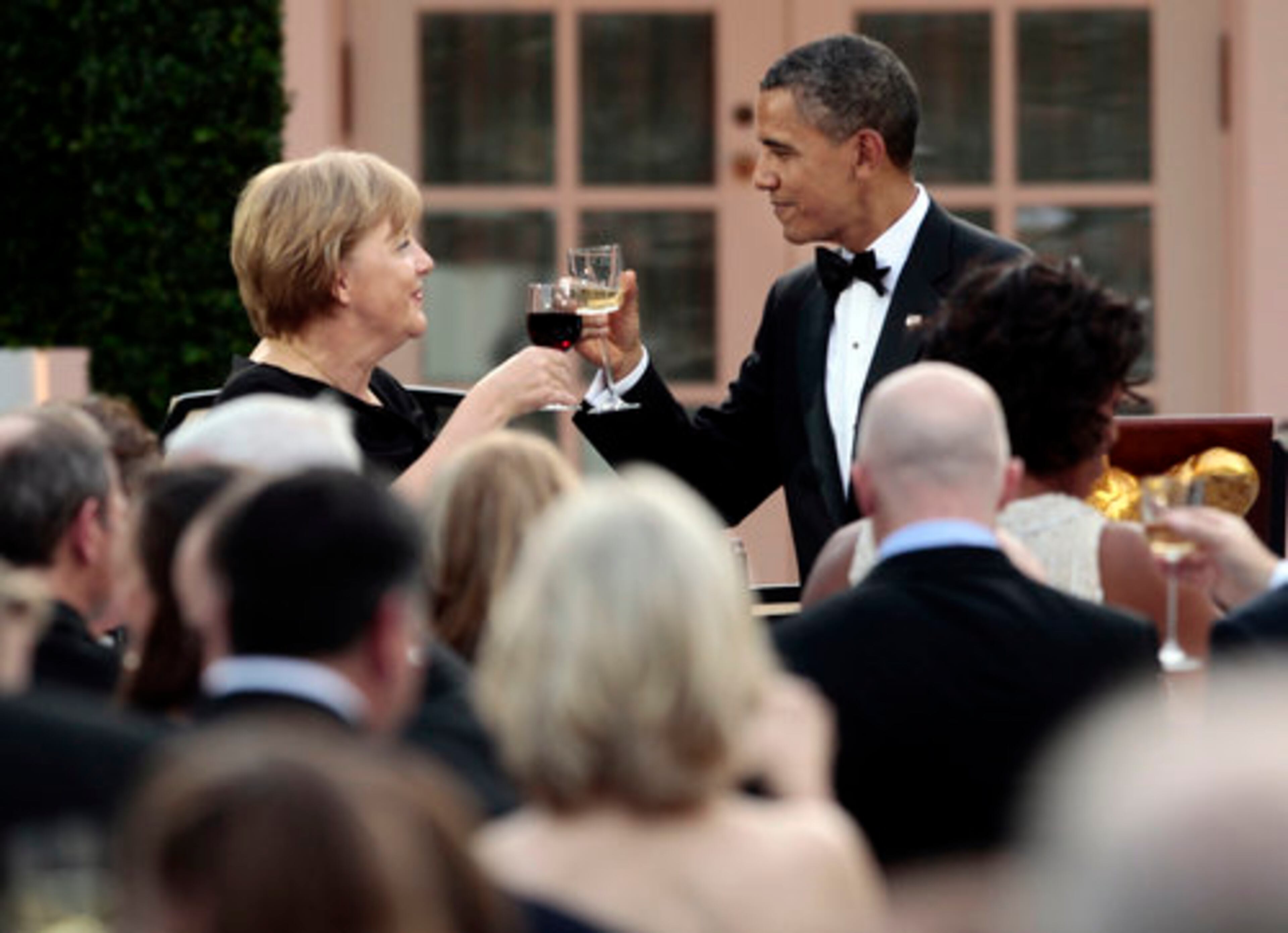 President Barack Obama offers a toast to German Chancellor Angela Merkel at the dinner in the White House Rose Garden.