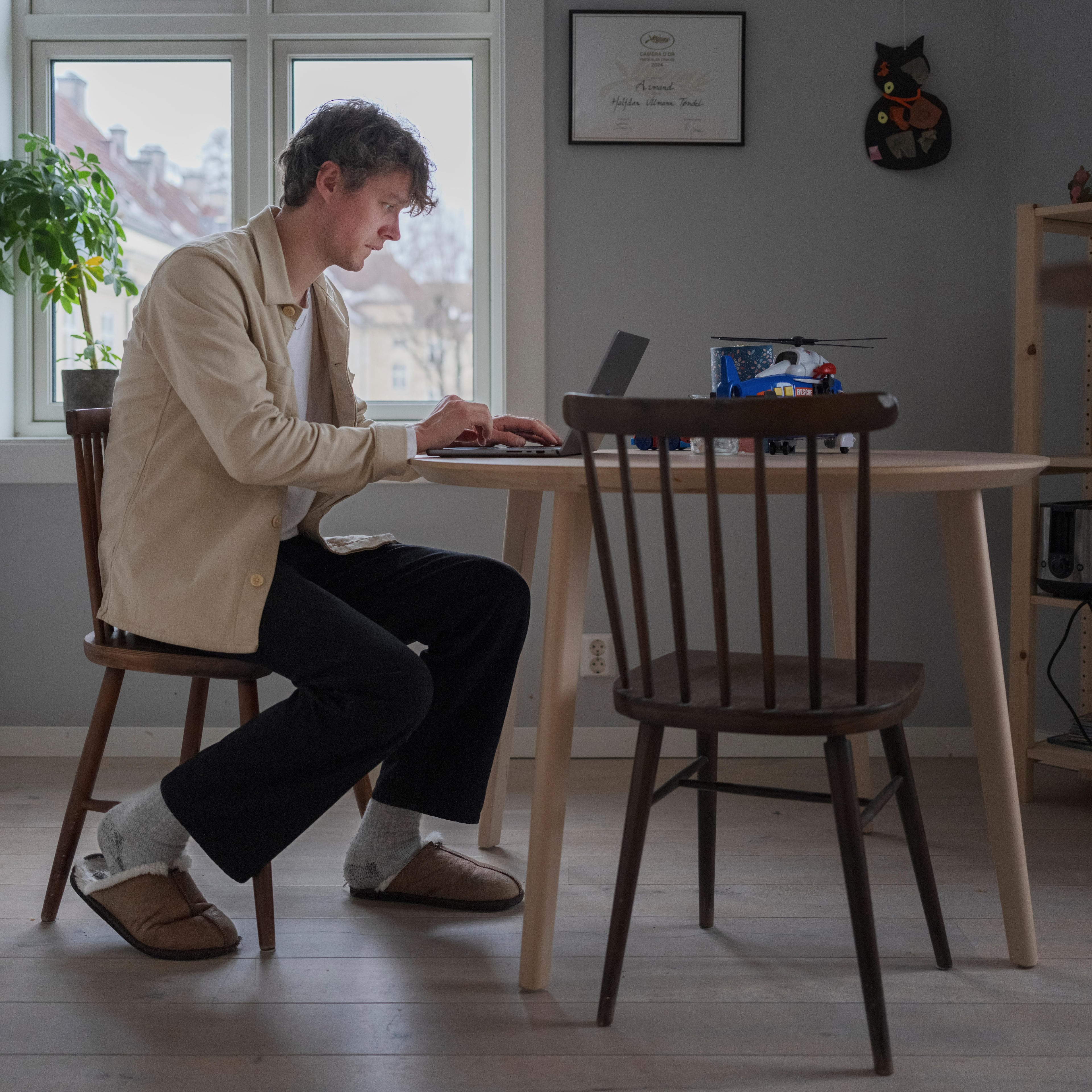 Halfdan Ullmann Tondel works on his computer in the kitchen in his apartment in Torshov, Norway on Jan. 30, 2025. (Andrea Gjestvang/The New York Times)