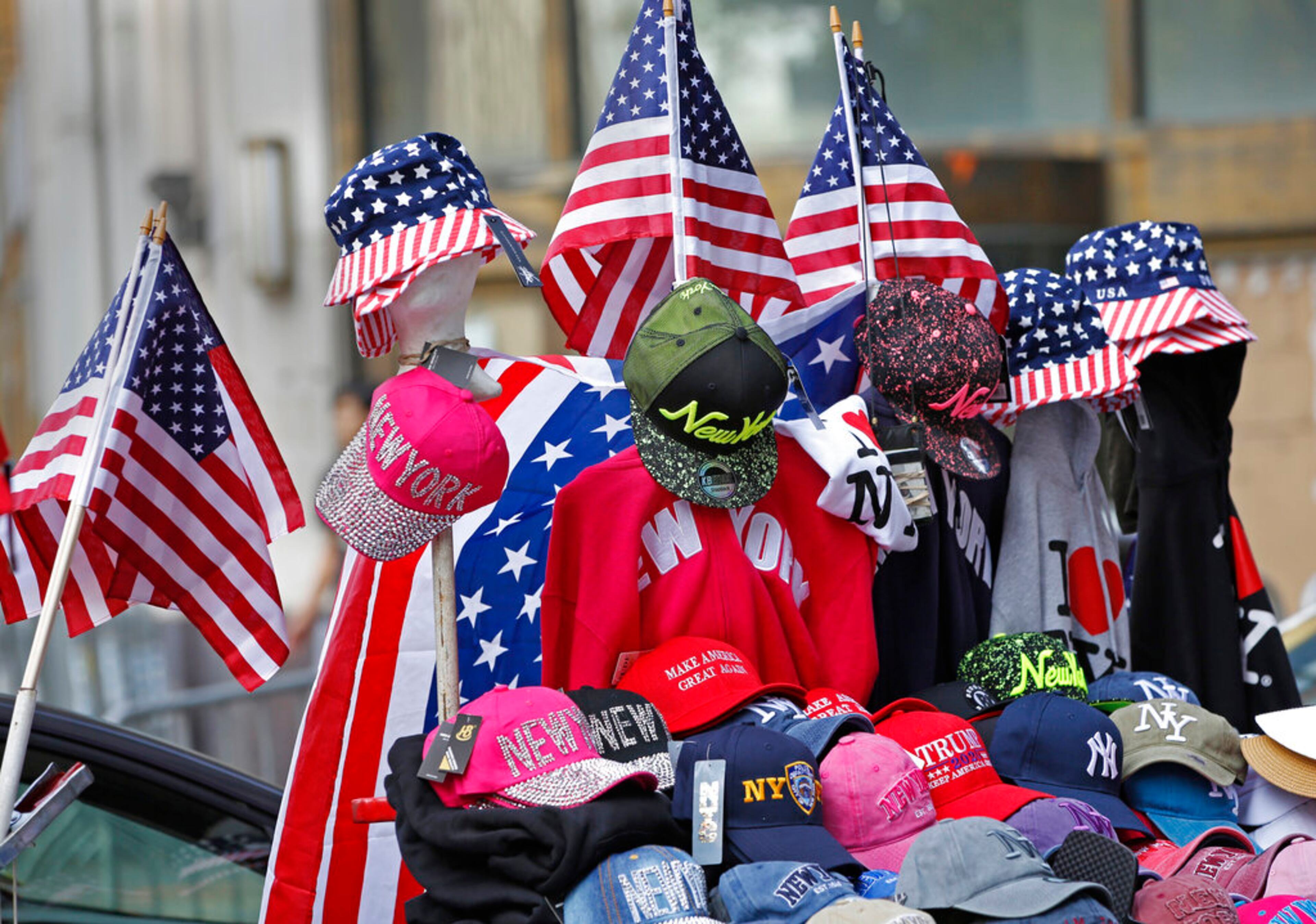 CORRECTS NICKNAME OF LOWER BROADWAY TO "CANYON OF HEROES", INSTEAD OF CANYON OF CHAMPIONS - Flag-themed souvenirs are for sale on Broadway, also known as the "Canyon of Heroes," along the parade route in lower Manhattan, one day ahead of a ticker-tape parade and City Hall ceremony for the four-time World Cup winning U.S. women's soccer team, Tuesday, July 9, 2019, in New York. (AP Photo/Kathy Willens)