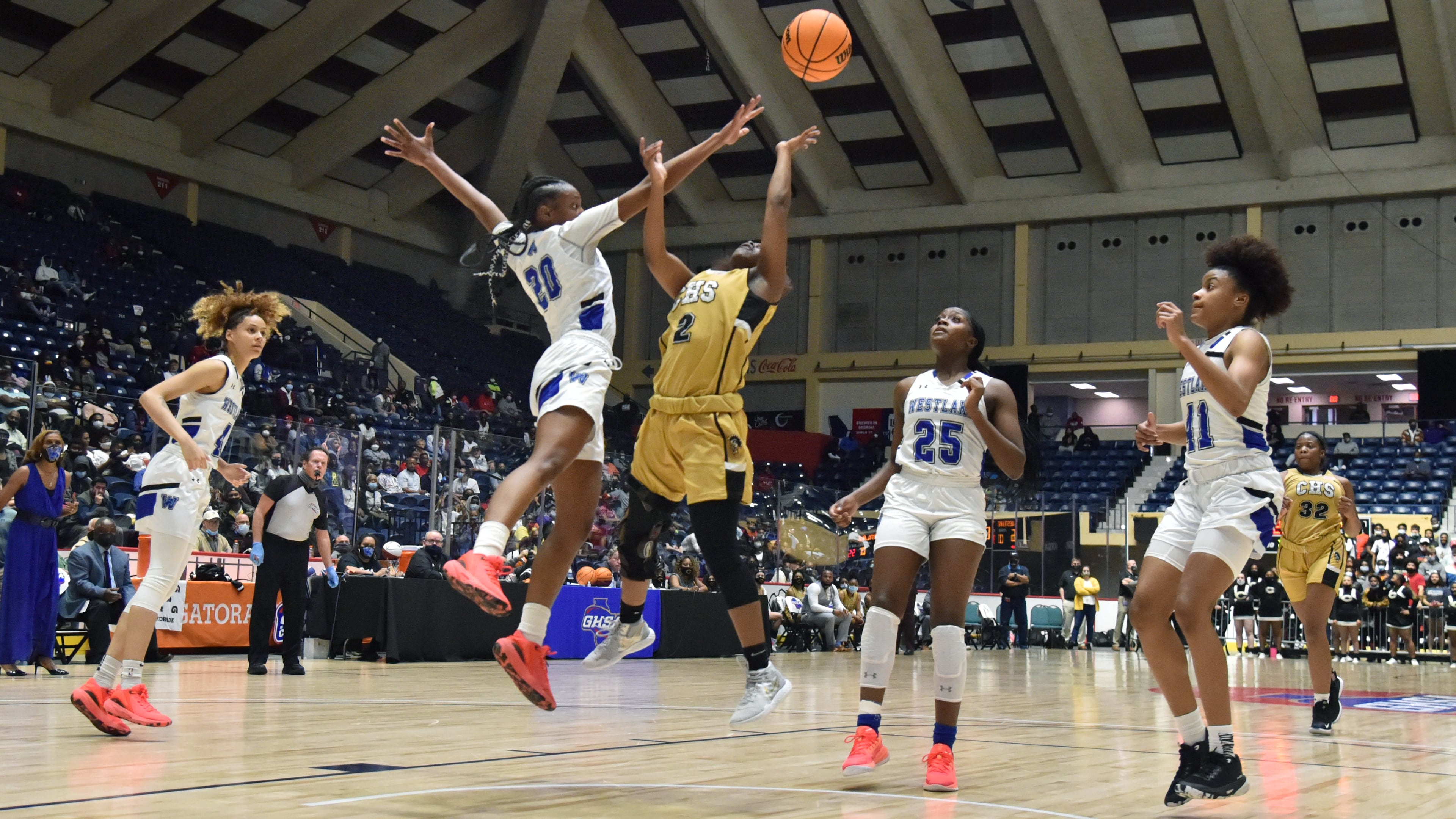 March 12, 2021 Macon - Carrollton's Kehinde Obasuyi (2) gets off a shot against Westlake's Taniya Latson (20) during the 2021 GHSA State Basketball Class AAAAAA Girls Championship game at the Macon Centreplex in Macon on Friday, March 12, 2021 Westlake won 64-46 over Carrollton. (Hyosub Shin / Hyosub.Shin@ajc.com)