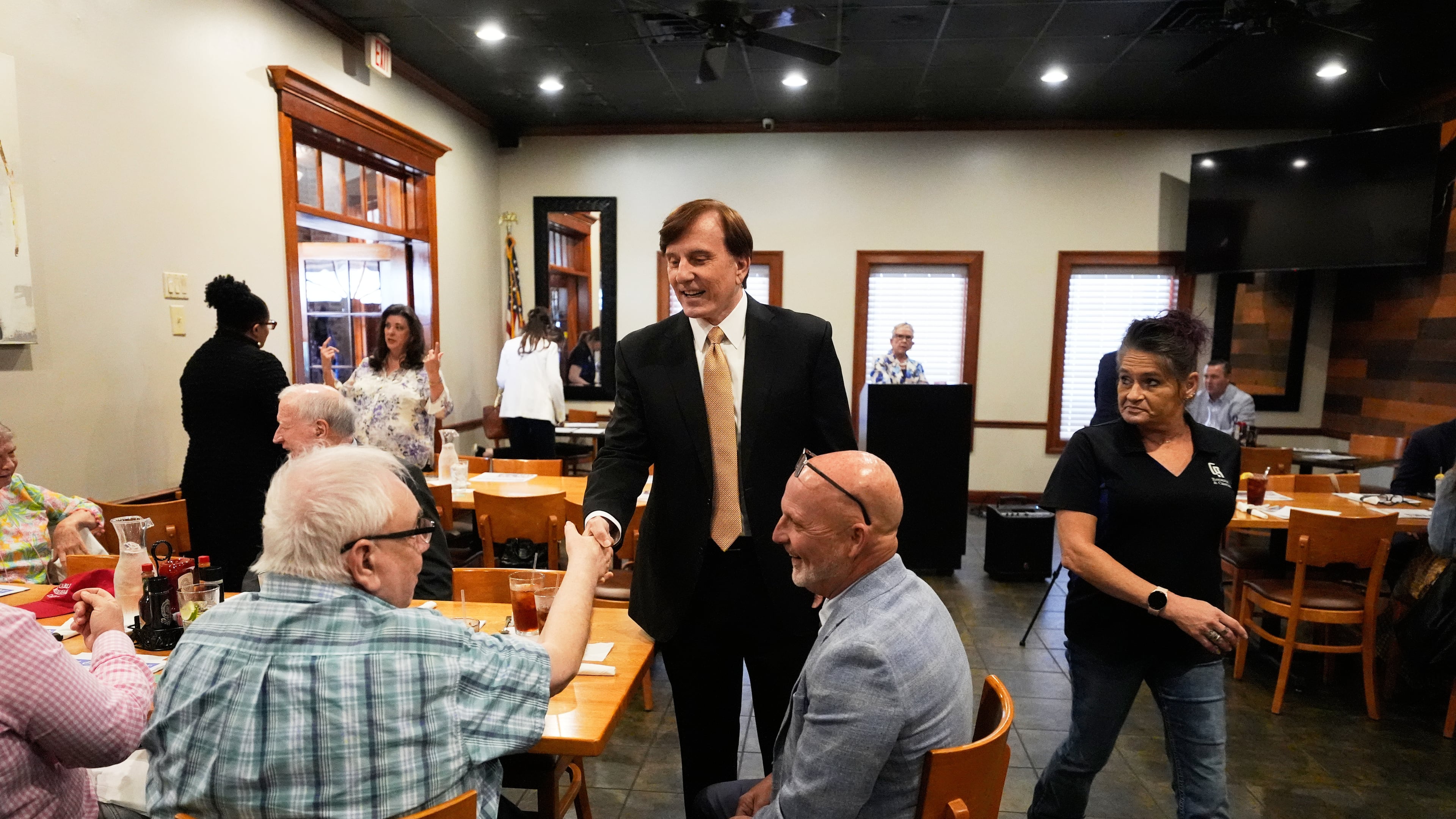 FILE - John Fleming, a U.S. Senate candidate, current Louisiana treasurer and former Republican House representative of Louisiana, greets supporters at a Ronald Reagan Newsmaker Luncheon in Baton Rouge, La., May 12, 2026. (AP Photo/Gerald Herbert, File)