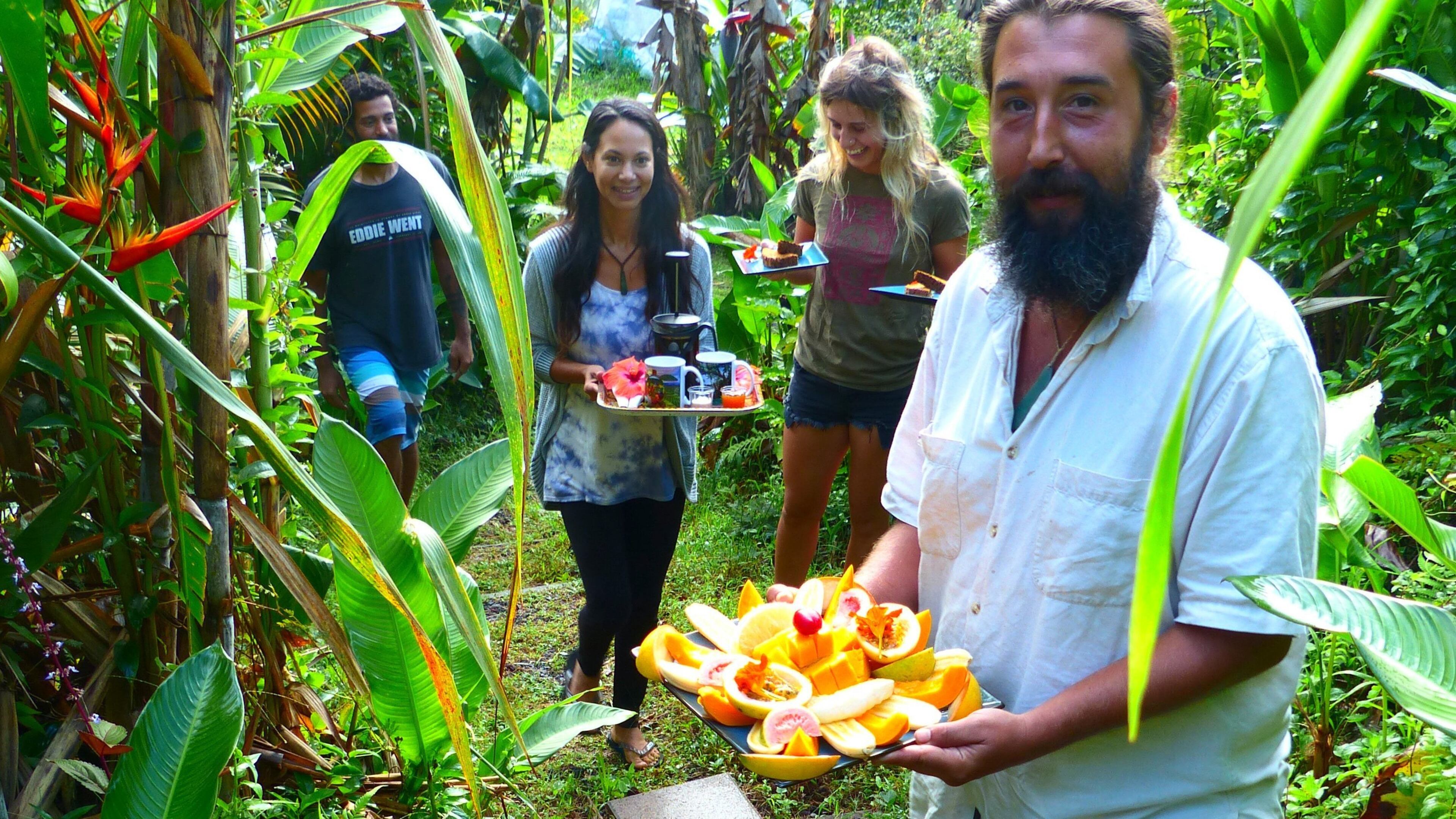 In a morning procession, including the tinkling bell of a triangle to announce their arrival, farm residents deliver breakfast to cabin guests on I'olani Farm. (Brian J. Cantwell/Seattle Times/TNS)