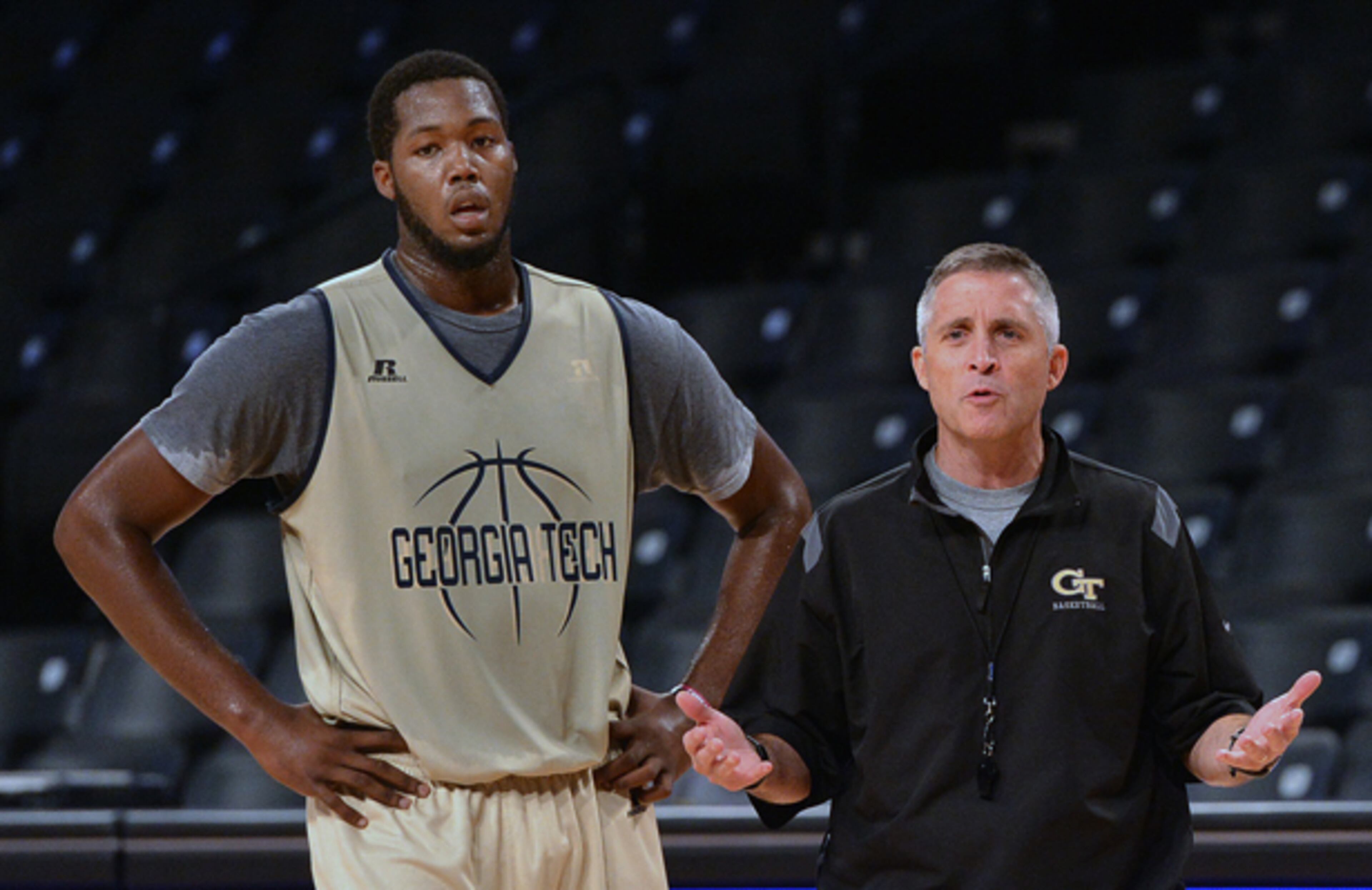 With freshman Robert Carter (left) standing by, Georgia Tech head coach Brian Gregory gives instruction to the team as the Yellow Jackets held their first practice Tuesday.