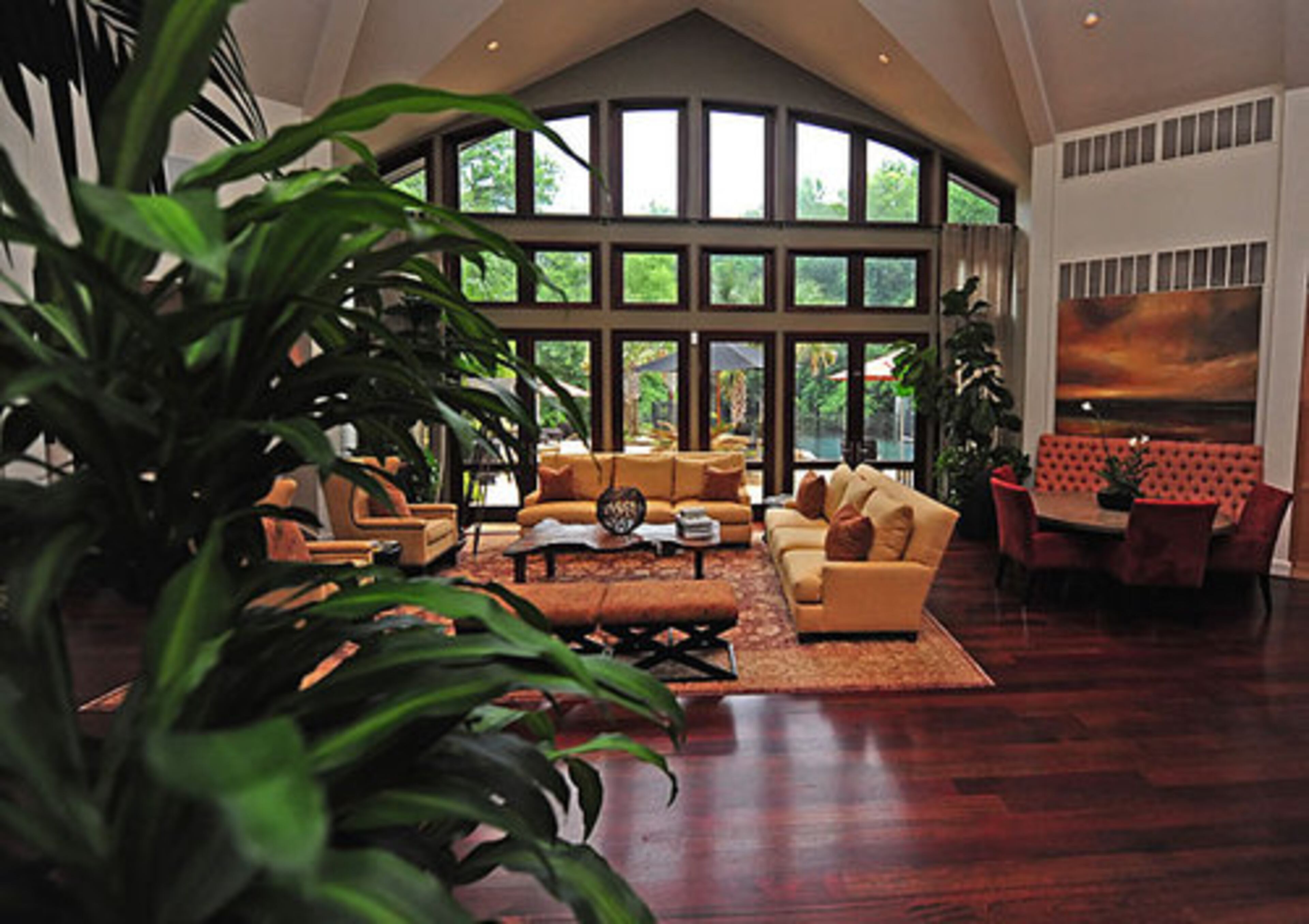 After buying the house, McCoy and Block initiated a renovation to add their own personal touches. They created this luminous cathedral wall of windows connecting the pool patio with the living room, highlighting the home's resort ambiance and woodsy locale. The 32-foot groin ceiling gives the room an airy feel, while Brazilian cherry floors impart a burnished glow.