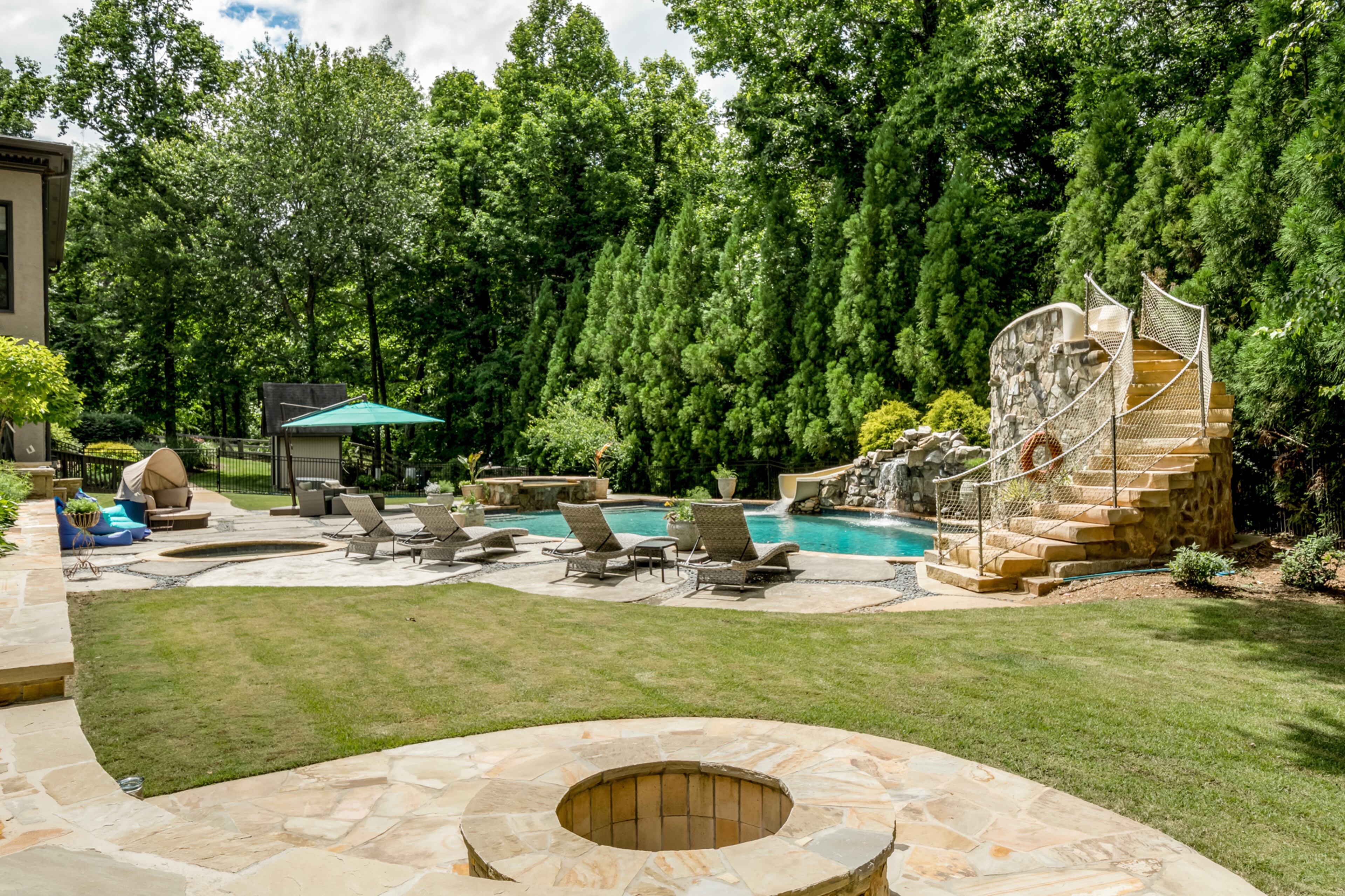 The 12-foot saltwater pool with custom slide and waterfall. Text by Melanie White.