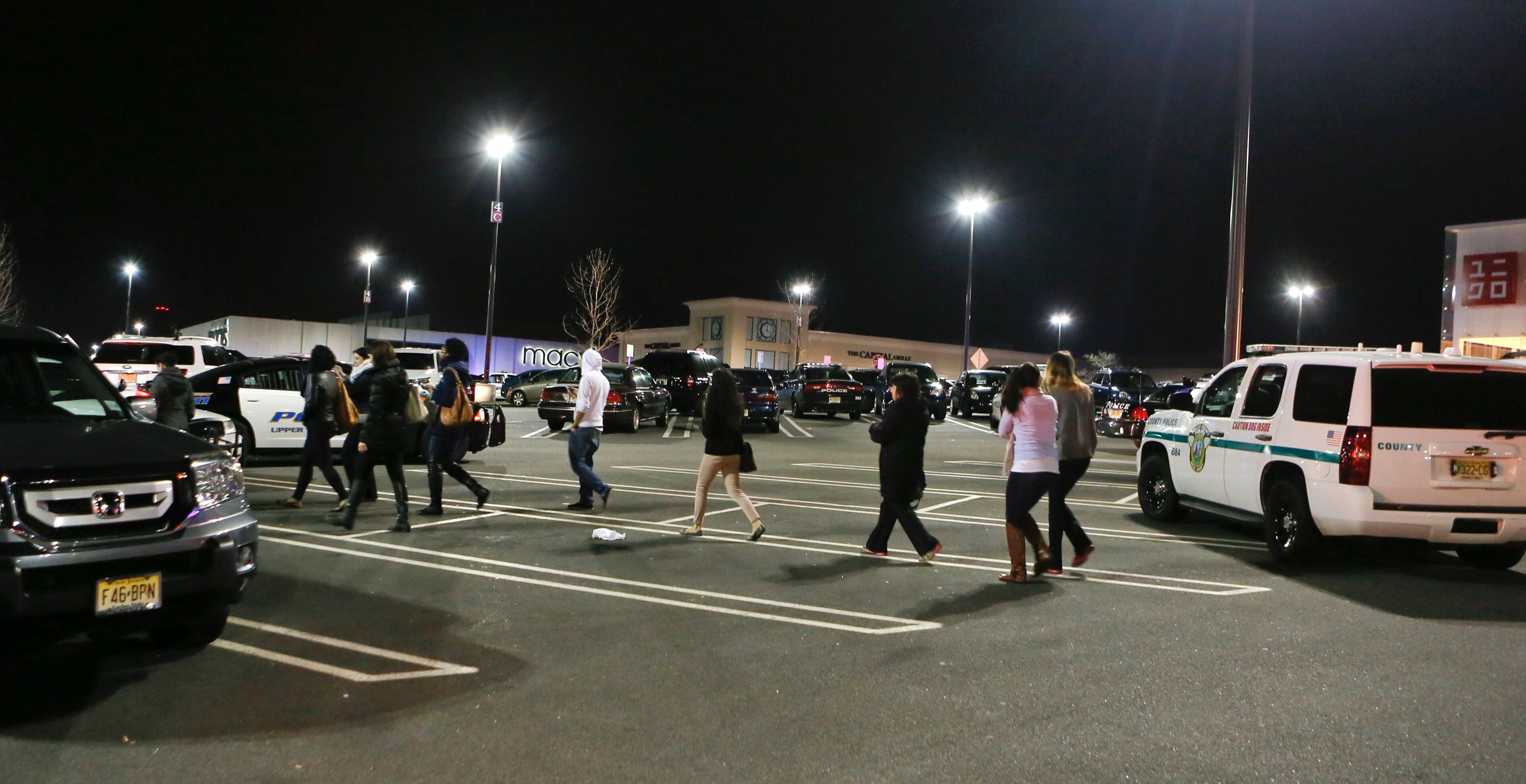 People look for their vehicles after exiting the Garden State Plaza mall following their release by police, who locked down the mall during their response to reports that a gunman had fired shots in the mall, in Paramus, New Jersey November 5, 2013. A person with a gun opened fire on Monday evening in the massive New Jersey shopping mall shortly before closing time, leading police to evacuate the mall and search for the shooter, but no injuries were reported, officials said. REUTERS/Ray Stubblebine