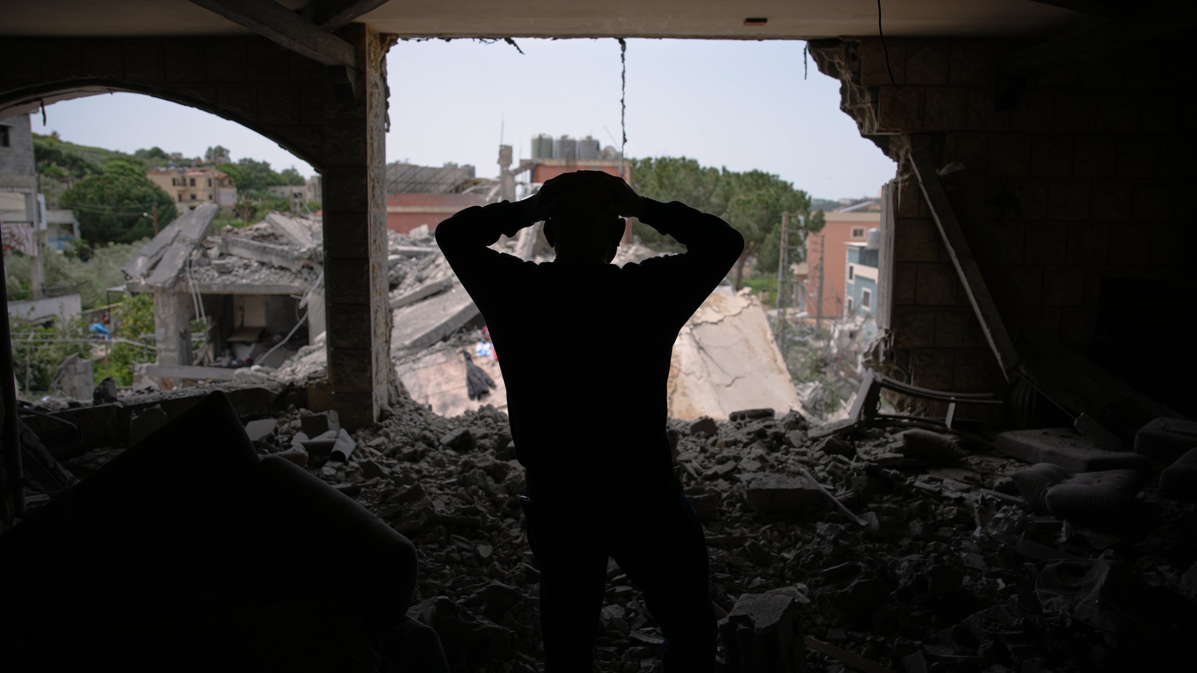 Assem Abdallah reacts as he enters his friend apartment destroyed in a Israeli airstrike in Kfar Roumman, southern Lebanon, Friday, April 17, 2026, following a ceasefire between Israel and Hezbollah. (AP Photo/Hassan Ammar)