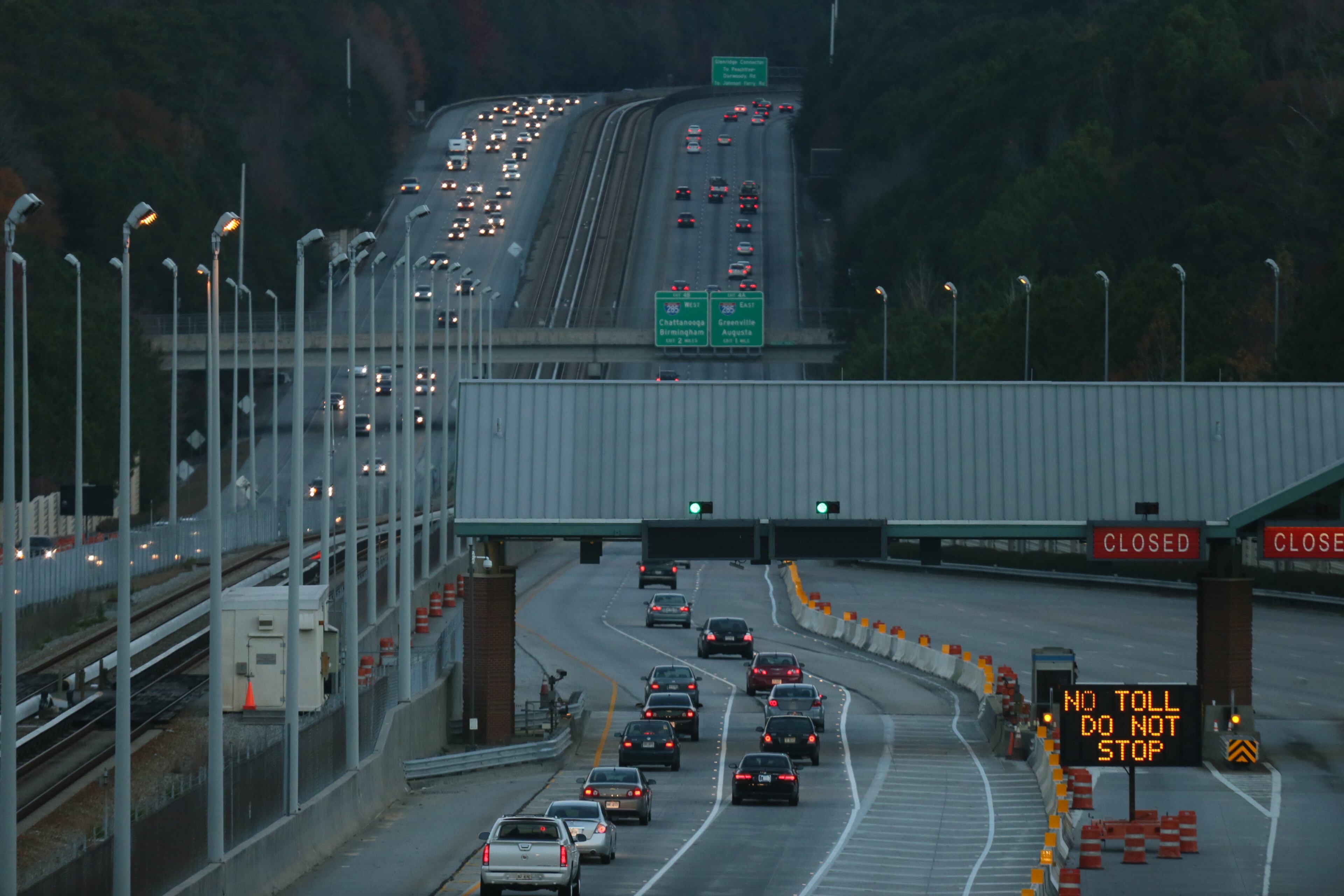 The scene at morning rush hour at the Ga 400 tolls. The tolls were closed on Friday after 20 years. Demolition of the toll will begin in January. Drivers can now use three lanes in each direction for free. However, the speed limit will be reduced to 45 mph through the construction zone while the work is in progress, and traffic will be rerouted through the Cruise Card lanes. BOB ANDRES/BANDRES@AJC.COM