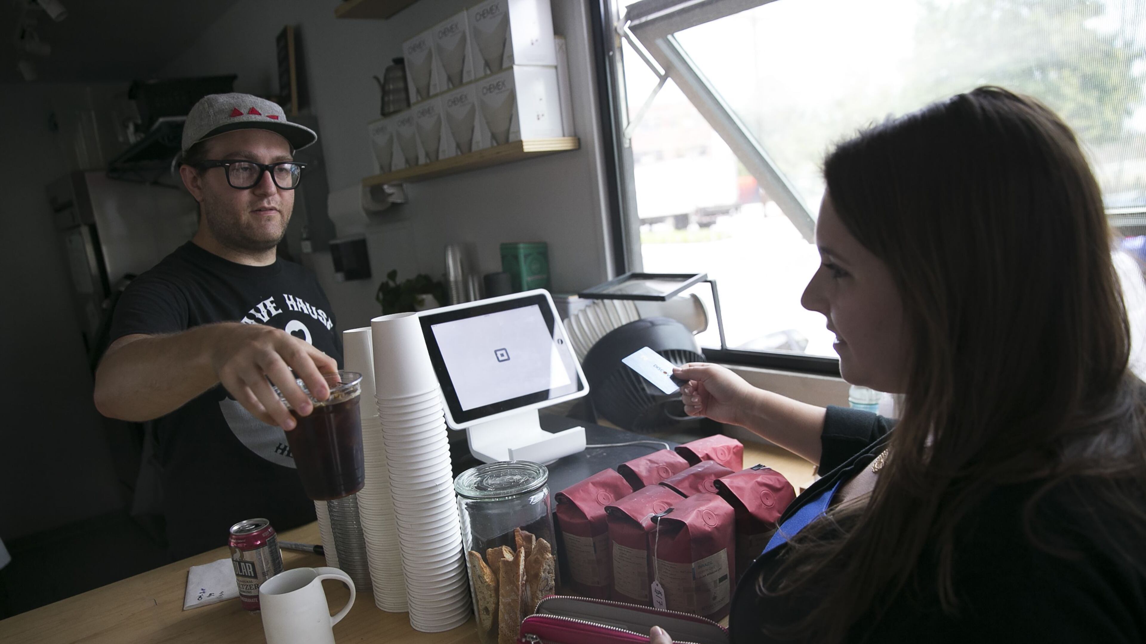 Rebecca Liebman, founder of a financial literacy site for millennials called LearnLux, pays for an iced coffee with her discover credit card at Triangle coffee in Boston, Aug. 12, 2016. Building a credit history holds less appeal for young Americans who had trouble paying off student loans and saw their families’ struggles during the financial crisis. (Katherine Taylor/The New York Times)