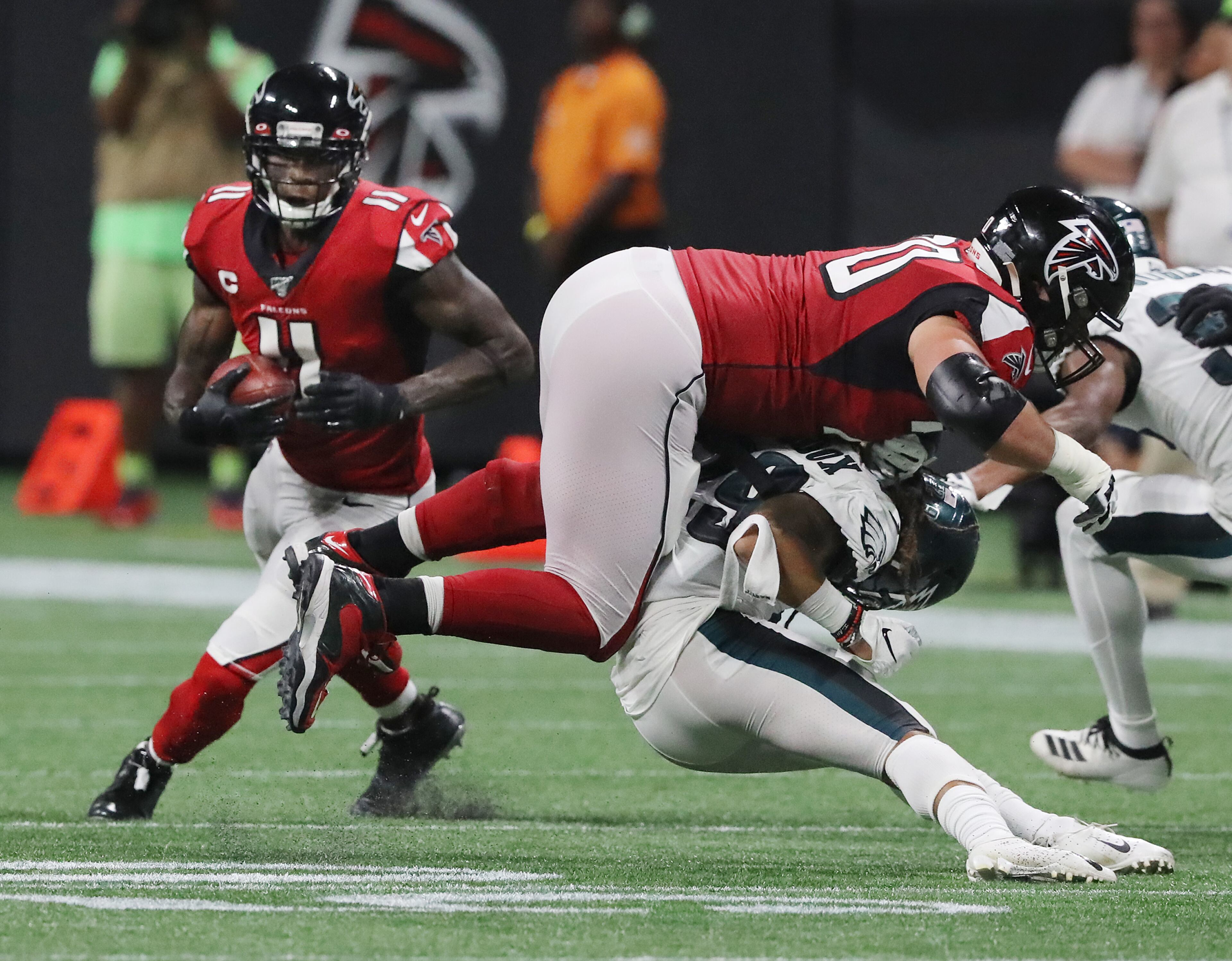 Falcons tackle Jake Matthews levels Philadelphia Eagles cornerback Avonte Maddox to free up wide receiver Julio Jones (left) for the long game winning touchdown. Curtis Compton/ccompton@ajc.com