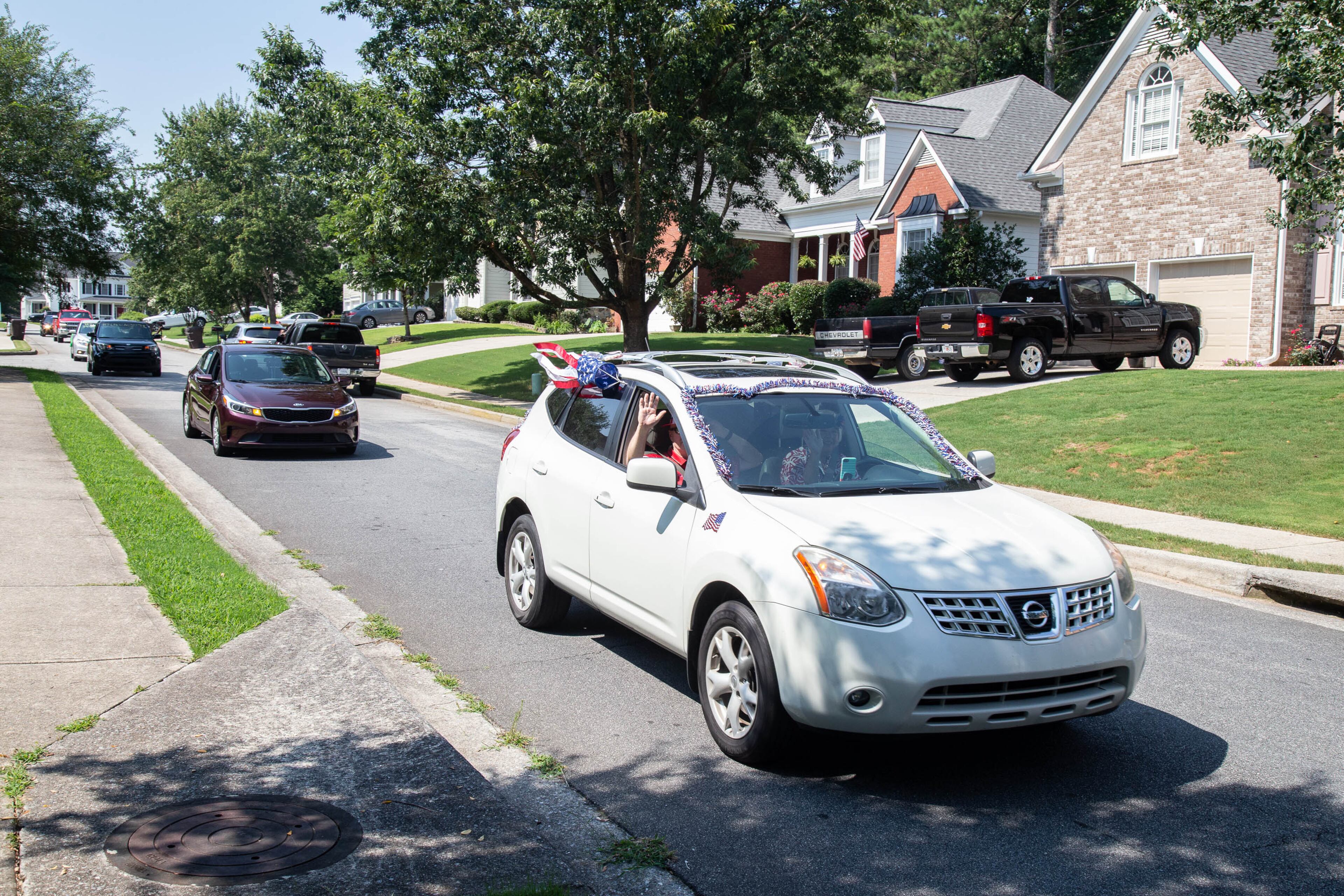 The 4th of July drive-by parade passed through their neighborhood in Powder Springs on Saturday, July 4, 2020. STEVE SCHAEFER FOR THE ATLANTA JOURNAL-CONSTITUTION