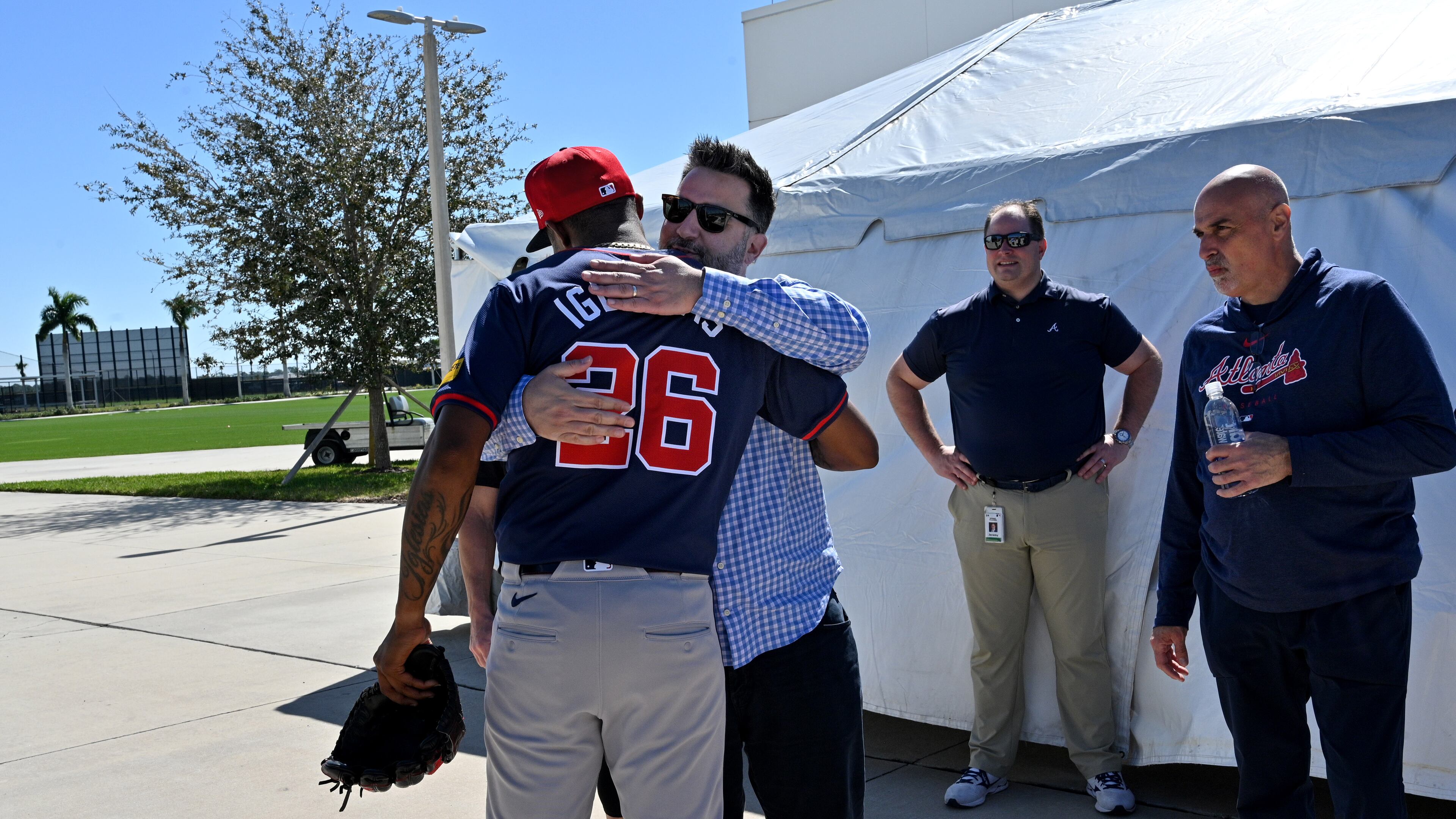 Atlanta Braves relief pitcher Raisel Iglesias is greeted by general manager Alex Anthopoulos after throwing in the bullpen during the first full-squad spring training workout at CoolToday Park, Tuesday, February, 20, 2024, in North Port, Florida. (Hyosub Shin / Hyosub.Shin@ajc.com)