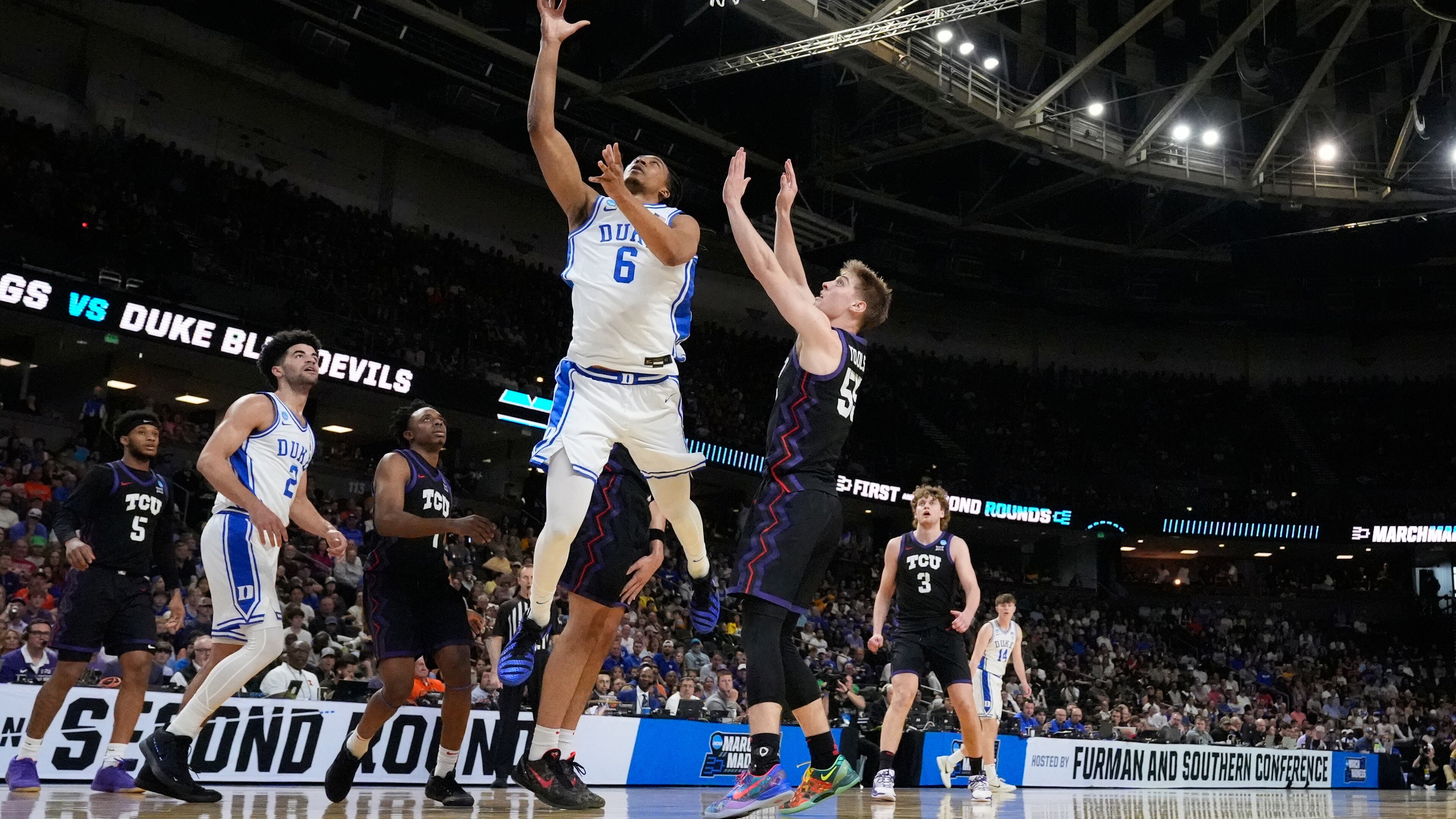 Duke forward Maliq Brown (6) shoots the ball against TCU guard Tanner Toolson (55) during the first half in the second round of the NCAA college basketball tournament, Saturday, March 21, 2026, in Greenville, S.C. (AP Photo/Brynn Anderson)