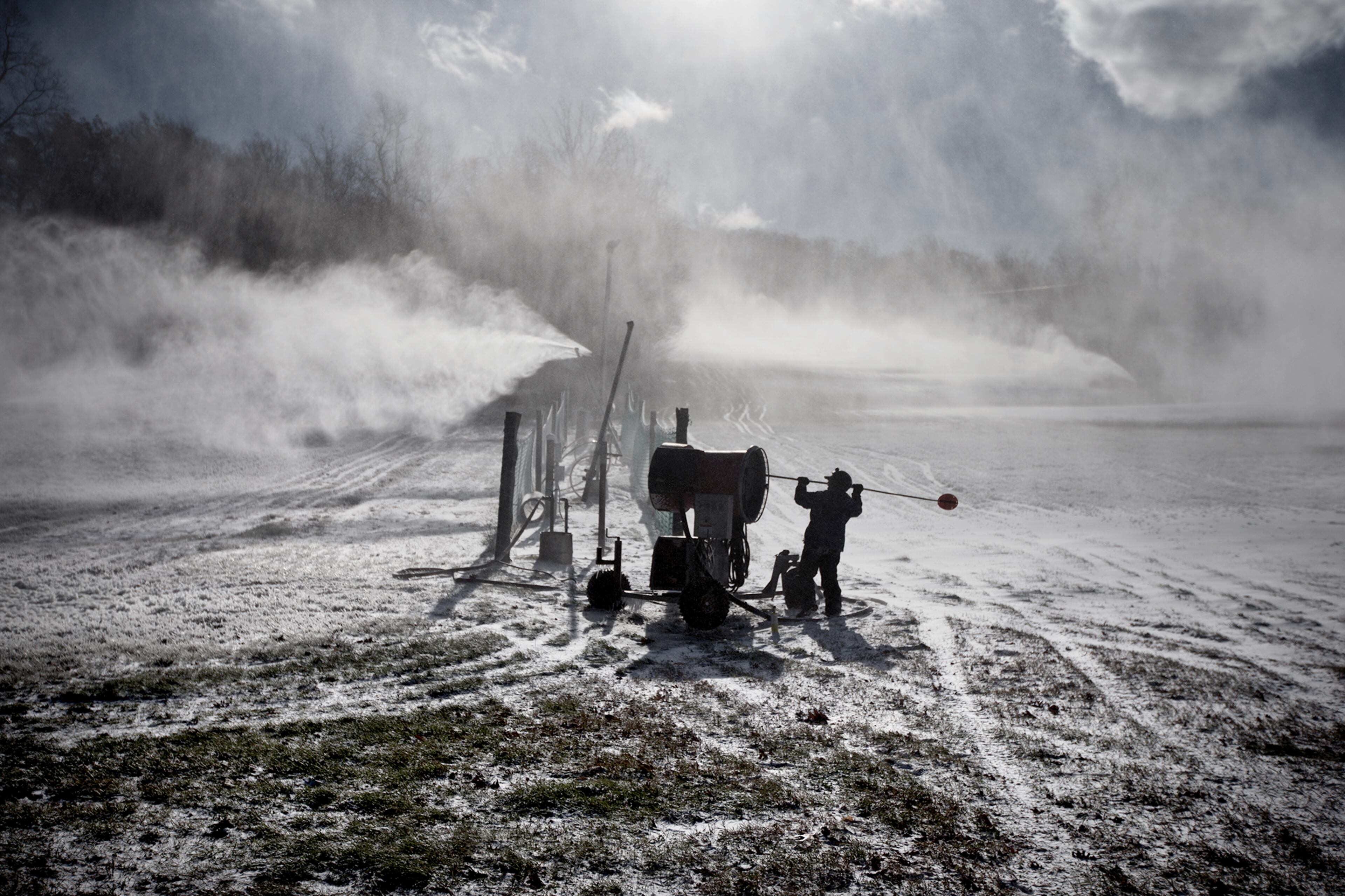 A Roundtop Mountain Resort employee makes snow in Lewisberry, Pa., Tuesday, Nov. 18, 2014, as arctic air arrived in the midstate area with temperatures struggling to reach 30 degrees. (AP Photo/PennLive.com, Sean Simmers)