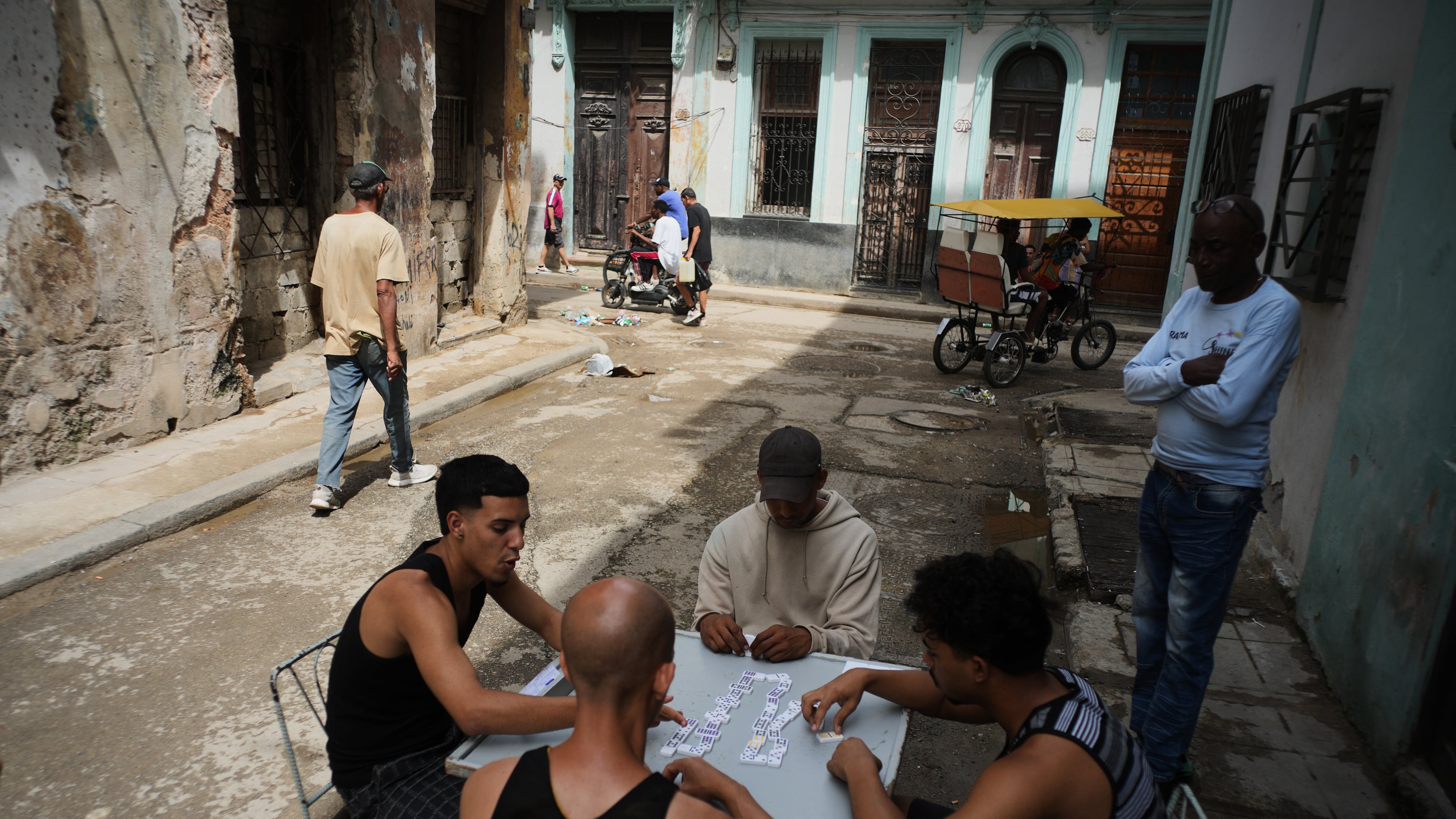 People play dominoes outside during a blackout in Havana, Tuesday, March 17, 2026. (AP Photo/Ramon Espinosa)