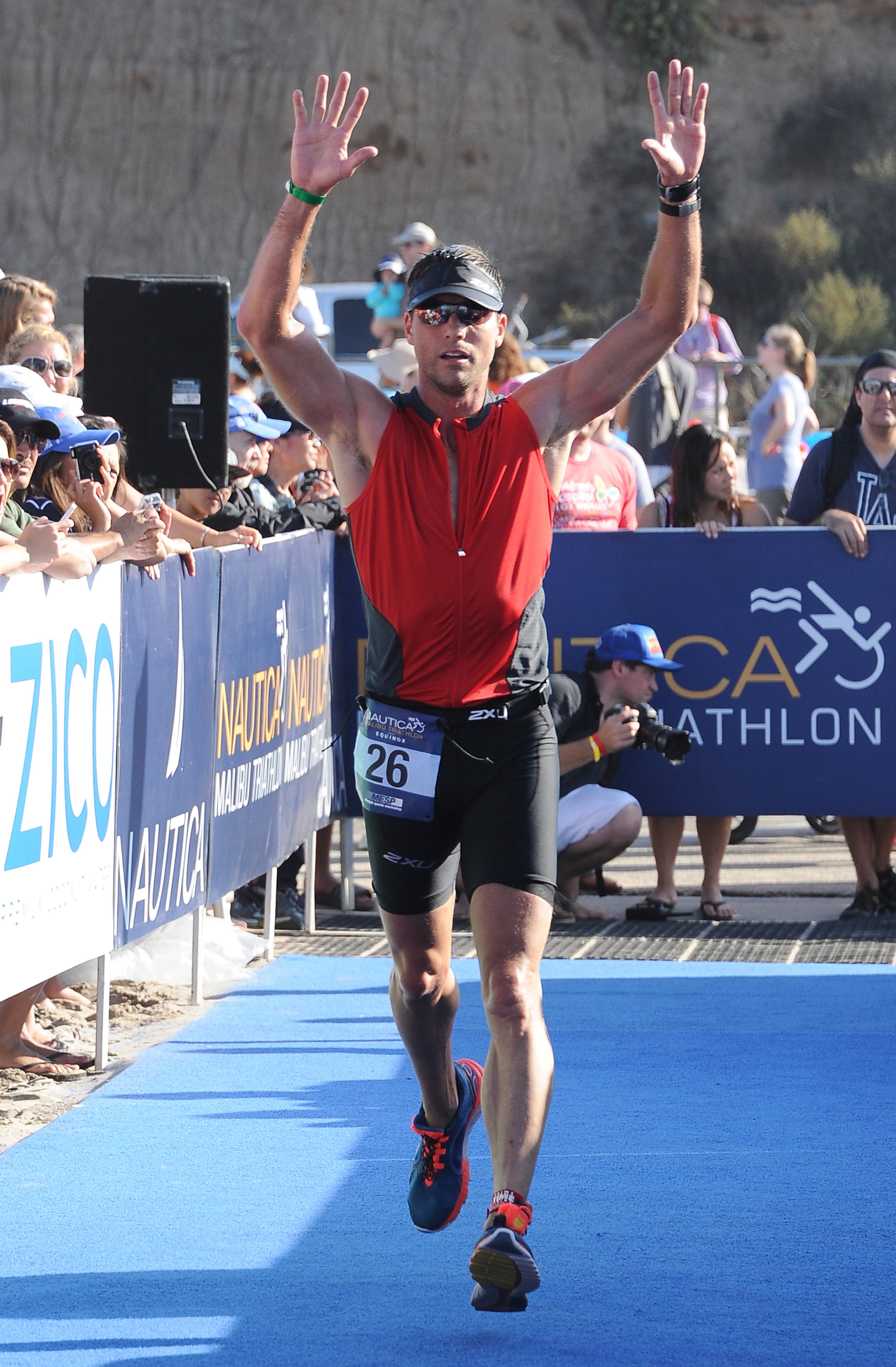 MALIBU, CA - SEPTEMBER 14: Actor Colin Egglesfield jogs toward the finish line during the Nautica Malibu Triathlon Presented by Equinox at Zuma Beach on September 14, 2014 in Malibu, California. (Photo by Noel Vasquez/Getty Images for Konnect PR / Nautica)
