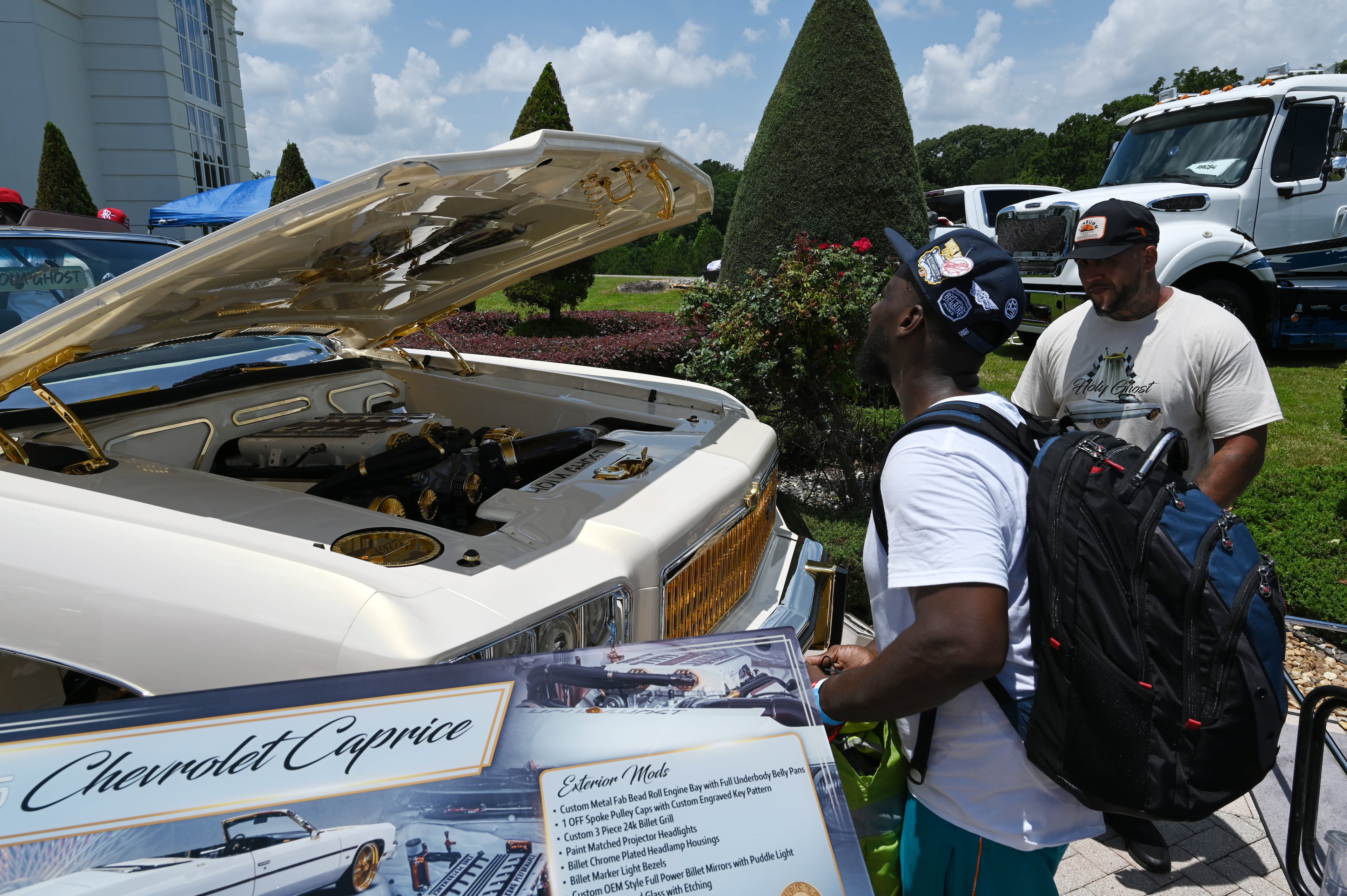 Attendees walk through fleets of classic/custom automobiles, luxury vehicles, boats, RVs and trailers on the front of the mansion during the 4th Annual Rick Ross Car and Bike Show, Saturday, June 7, 2025, in Fayetteville. The 4th Annual Rick Ross Car and Bike Show will include a vendor market with more than 30 vendors, food trucks, fleets of classic/custom automobiles, luxury vehicles, boats, RVs and trailers on the front of the mansion. Stage performances include Plies, Ross' new signee Nino Breeze and Ross himself. (Hyosub Shin / AJC)