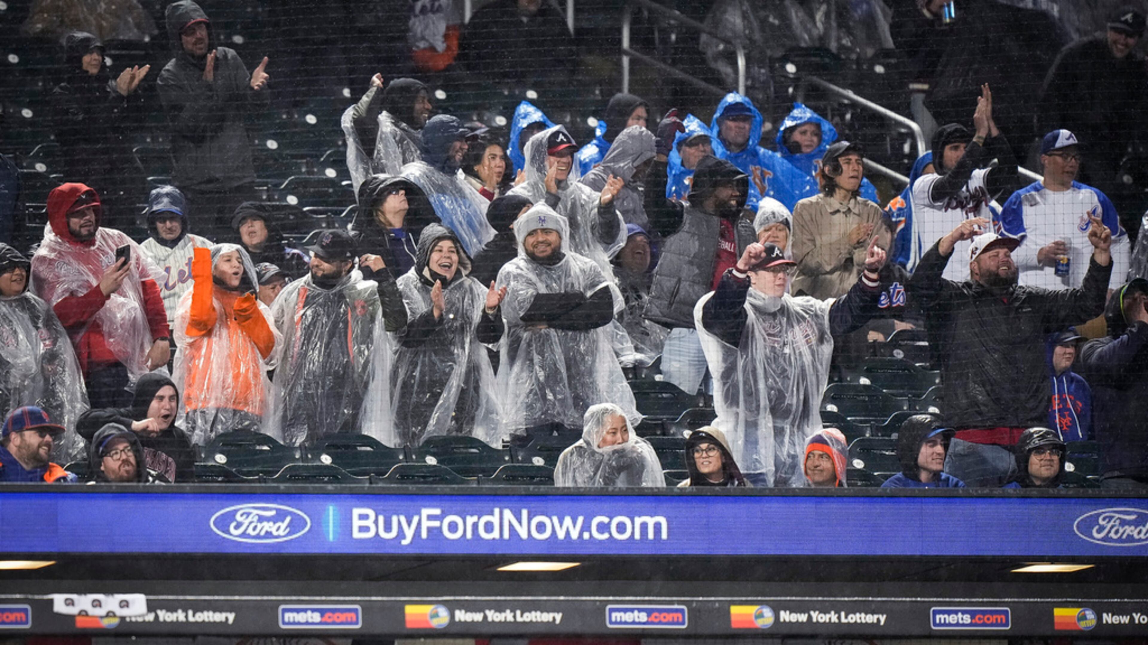 Braves fans celebrate after Matt Olson hit a home run during the fifth inning of the team's baseball game against the New York Mets, Friday, April 28, 2023, in New York. (AP Photo/Bryan Woolston)