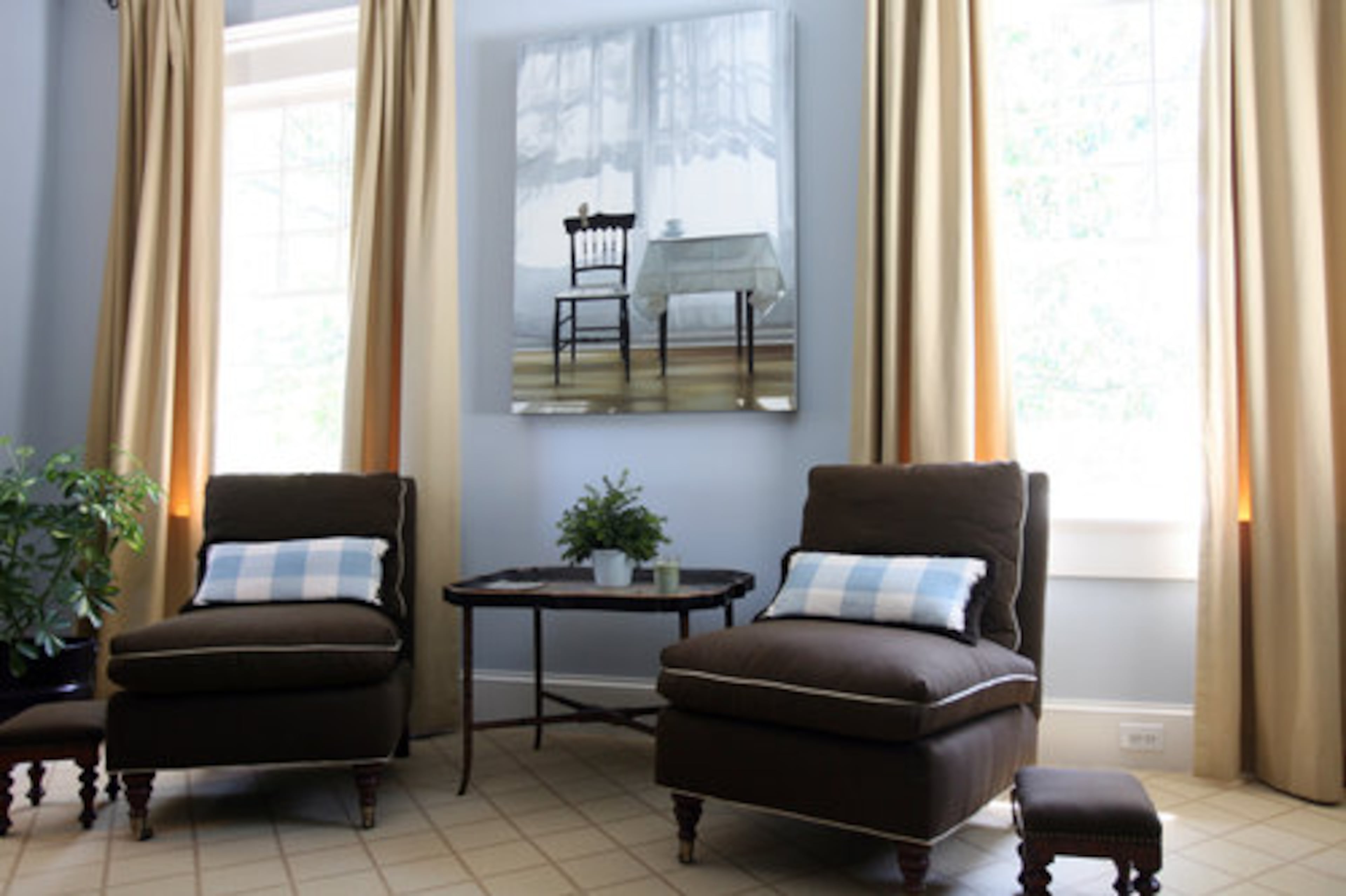 A painting by Karen Hollingsworth hangs above two chairs in the master bedroom in Susan Gibbs' home.