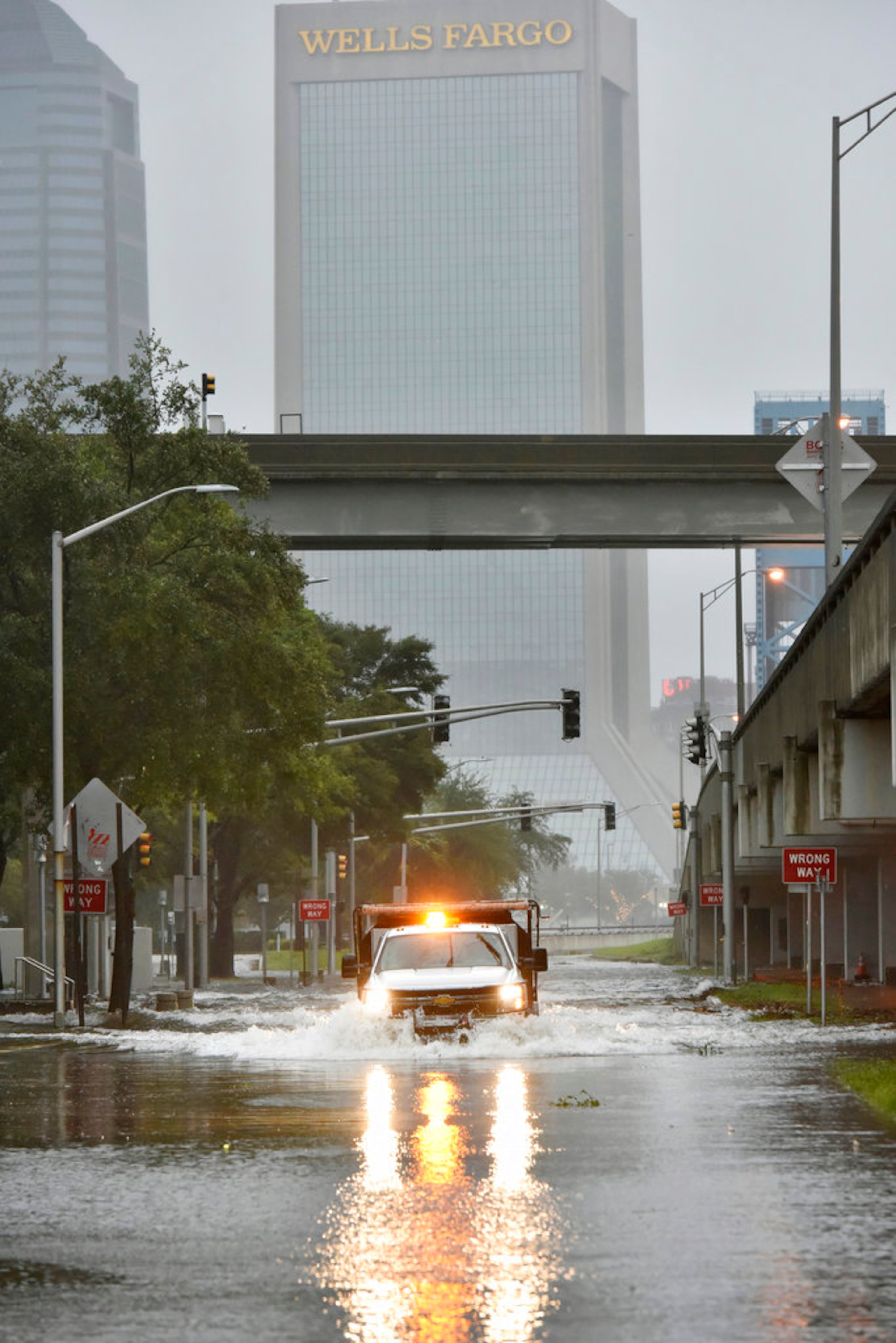 An Urban Flood Water Rescue Team with the Jacksonville Fire and Rescue Department makes its way along a flooded street on the Southbank of downtown as Hurricane Irma passes by Monday, Sept. 11, 2017 in Jacksonville, Fla. (Will Dickey/The Florida Times-Union via AP)