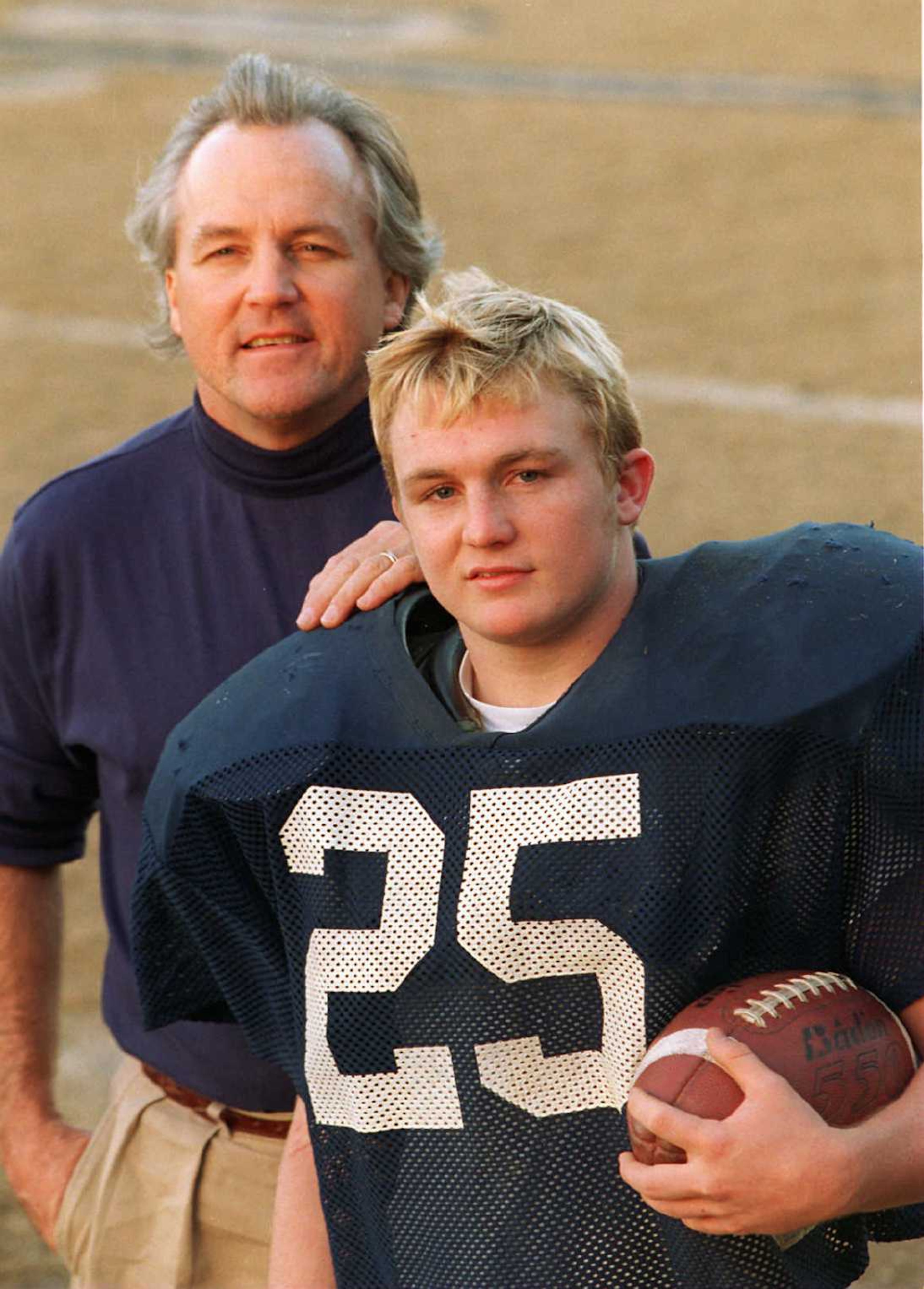 Randy Rhino (left) with his son Kelley at Marist School in 1996. (AJC file photo)