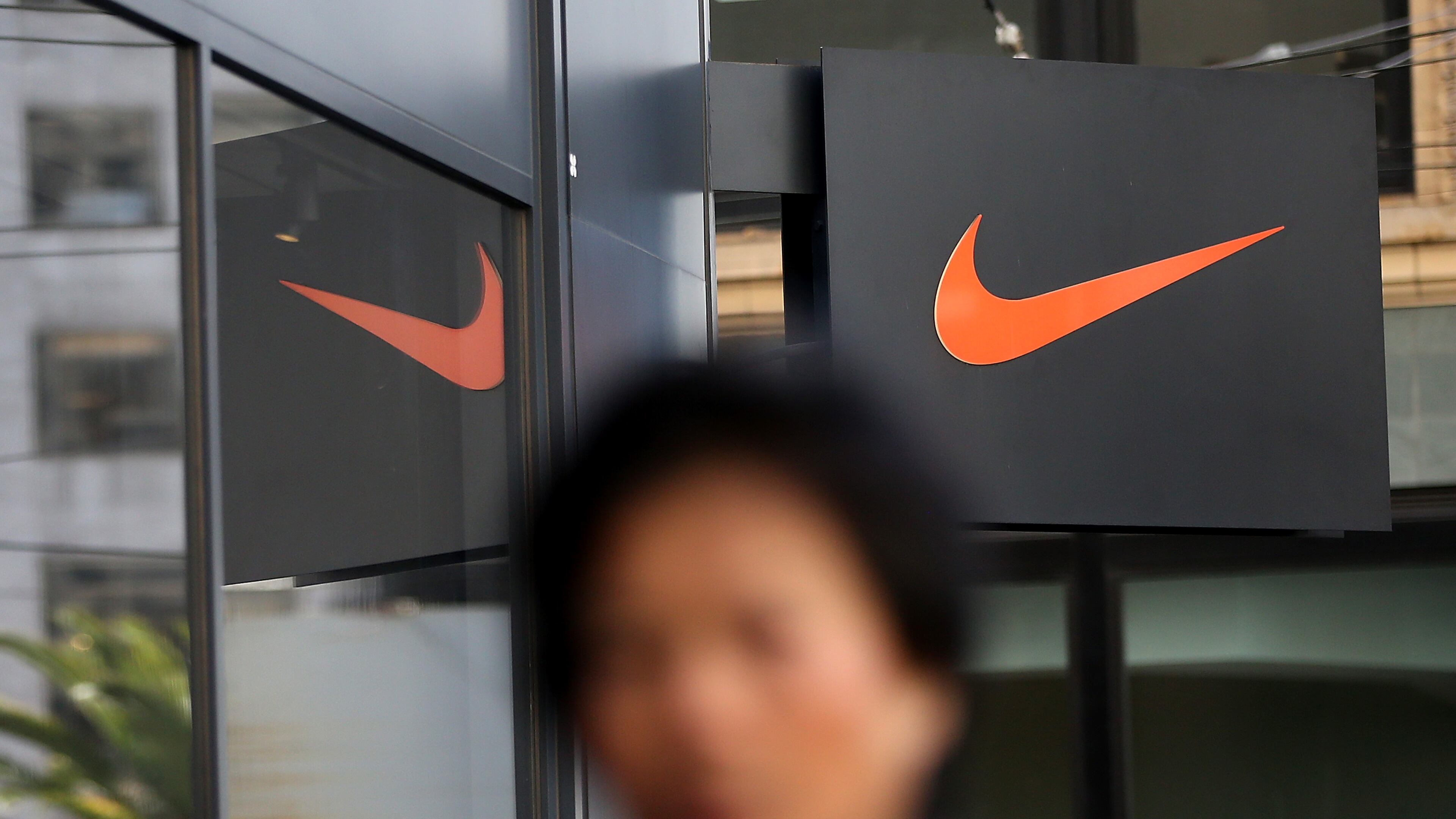 SAN FRANCISCO, CA - MARCH 22: A pedestrian walks by a Nike store on March 22, 2016 in San Francisco, California. Nike Inc. will announce third-quarter earnings after the closing bell. (Photo by Justin Sullivan/Getty Images)