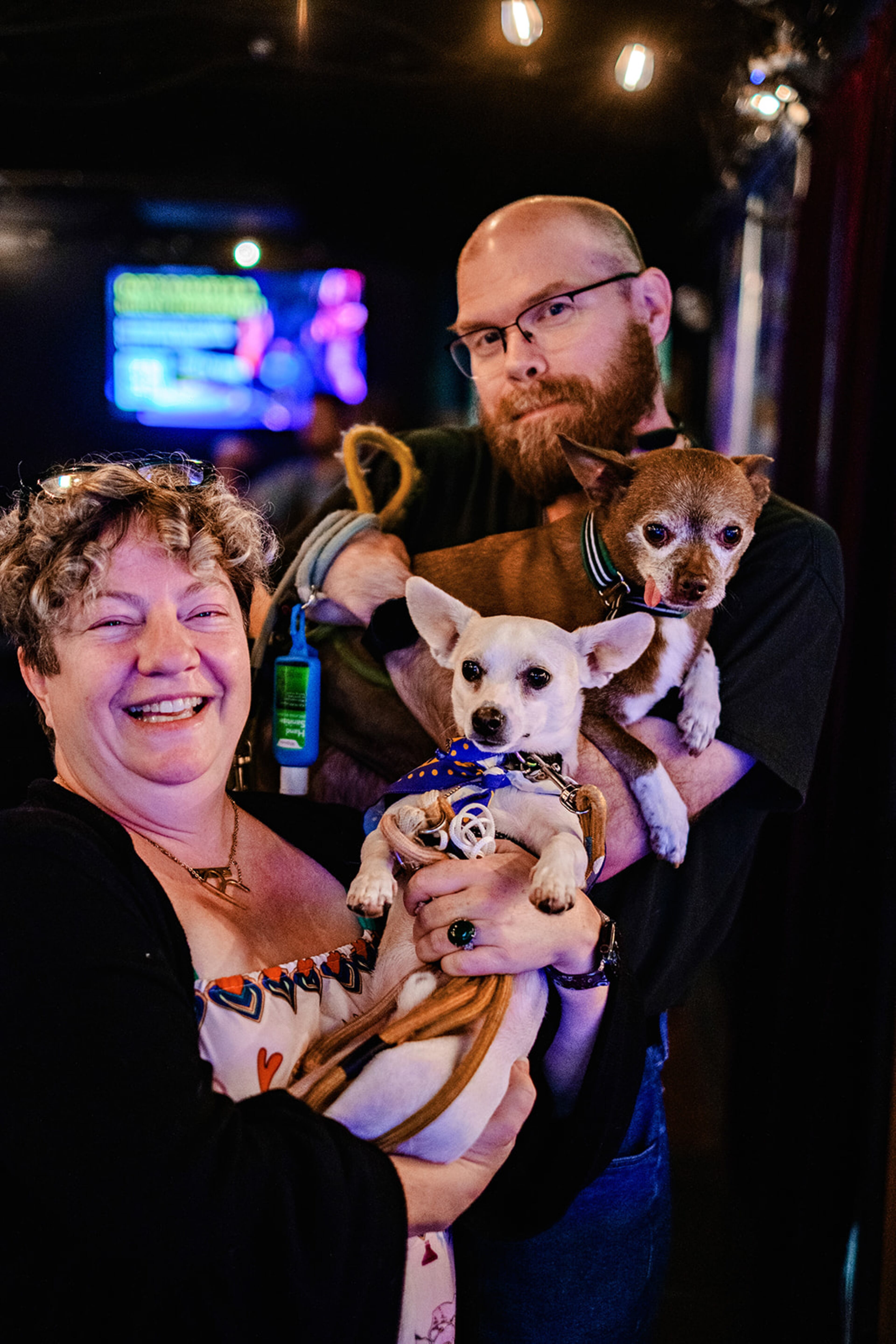 Robin Thornett (left) and her friend and Dad’s Garage volunteer Adam Coker hold Petey Rascal (front) and Leroy Brown at Dad's Garage. Petey is up for adoption. (Courtesy of Chelsea Patricia / Dad's Garage)