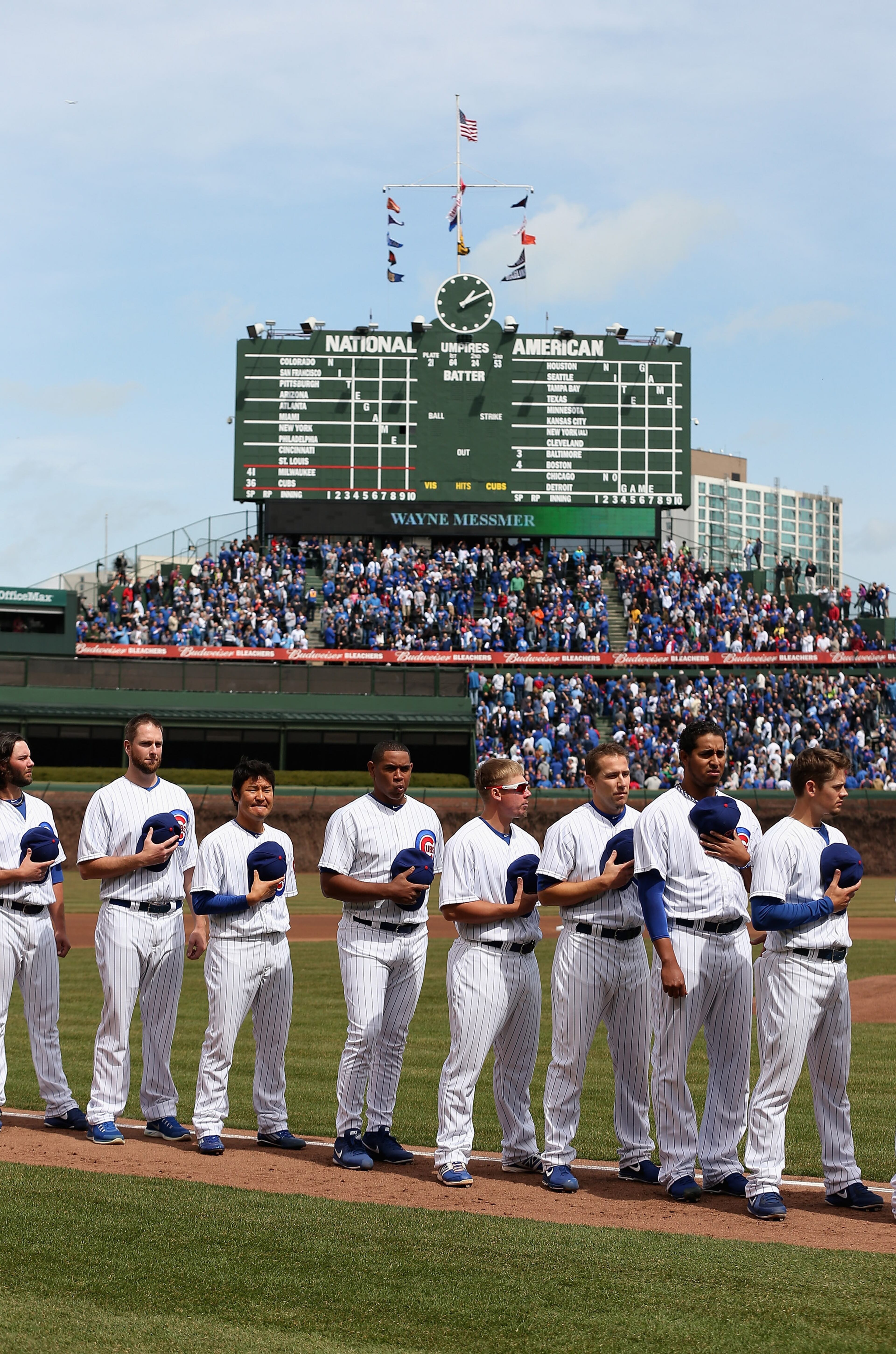 CHICAGO, IL - APRIL 08: Members of the Chicago Cubs stand during the National Anthem before the Opening Day game at Wrigley Field on April 8, 2013 in Chicago, Illinois. (Photo by Jonathan Daniel/Getty Images)