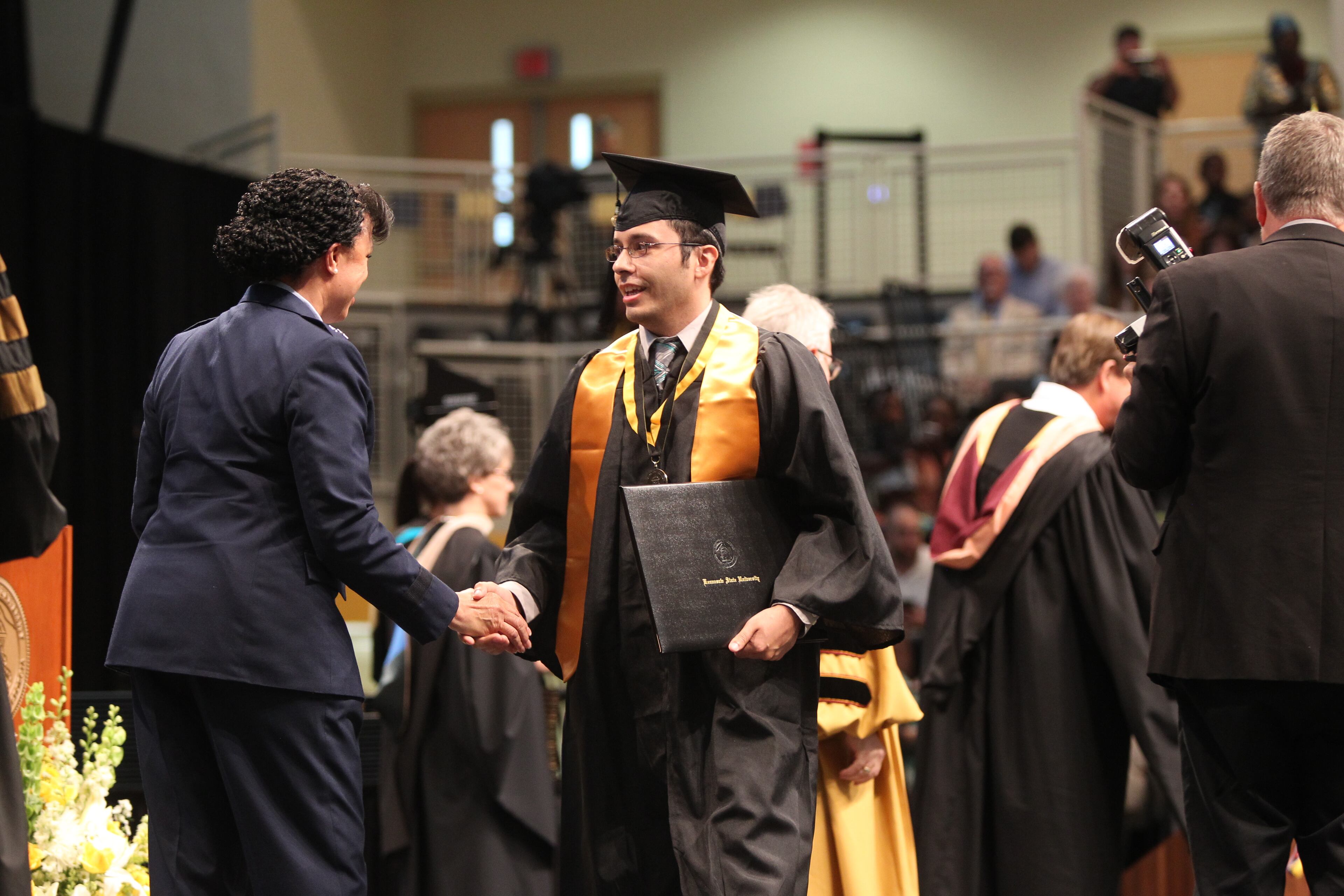 May 10, 2017, Atlanta, Georgia - Students along with their family and friends from Kennesaw State University in the College of Humanities and Social Sciences attend their Commencement ceremony to graduate from the university in Kennesaw, Georgia, on May 10, 2017. Graduates receive their diplomas and shake hands with Stayce D. Harris. (HENRY TAYLOR / HENRY.TAYLOR@AJC.COM)