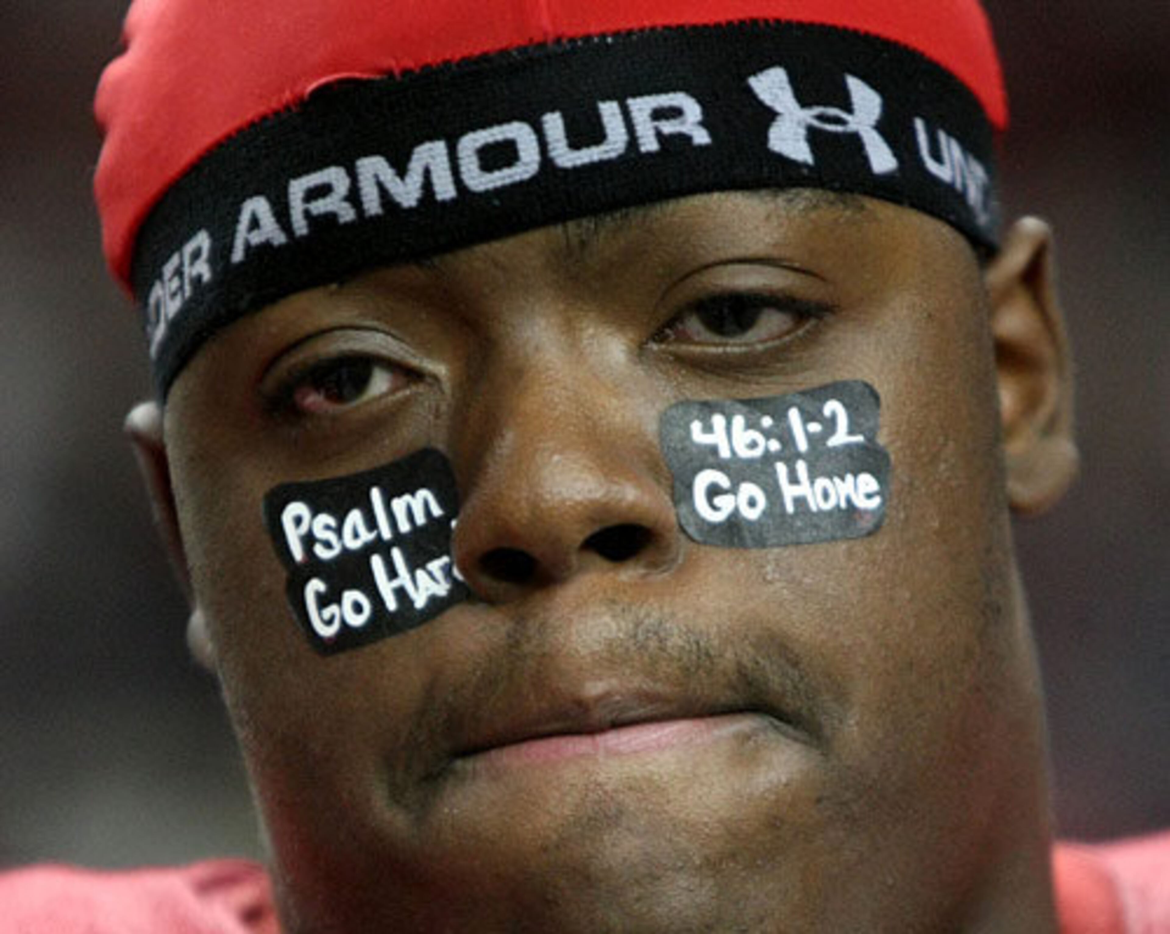 Savannah Christian lineman Deangelo Brown stands with teammates during the coin toss with a personal message on his eye black before their game against Clinch County in the Class A final. The message reads: "Psalm 46:12, Go Hard, Go Home."