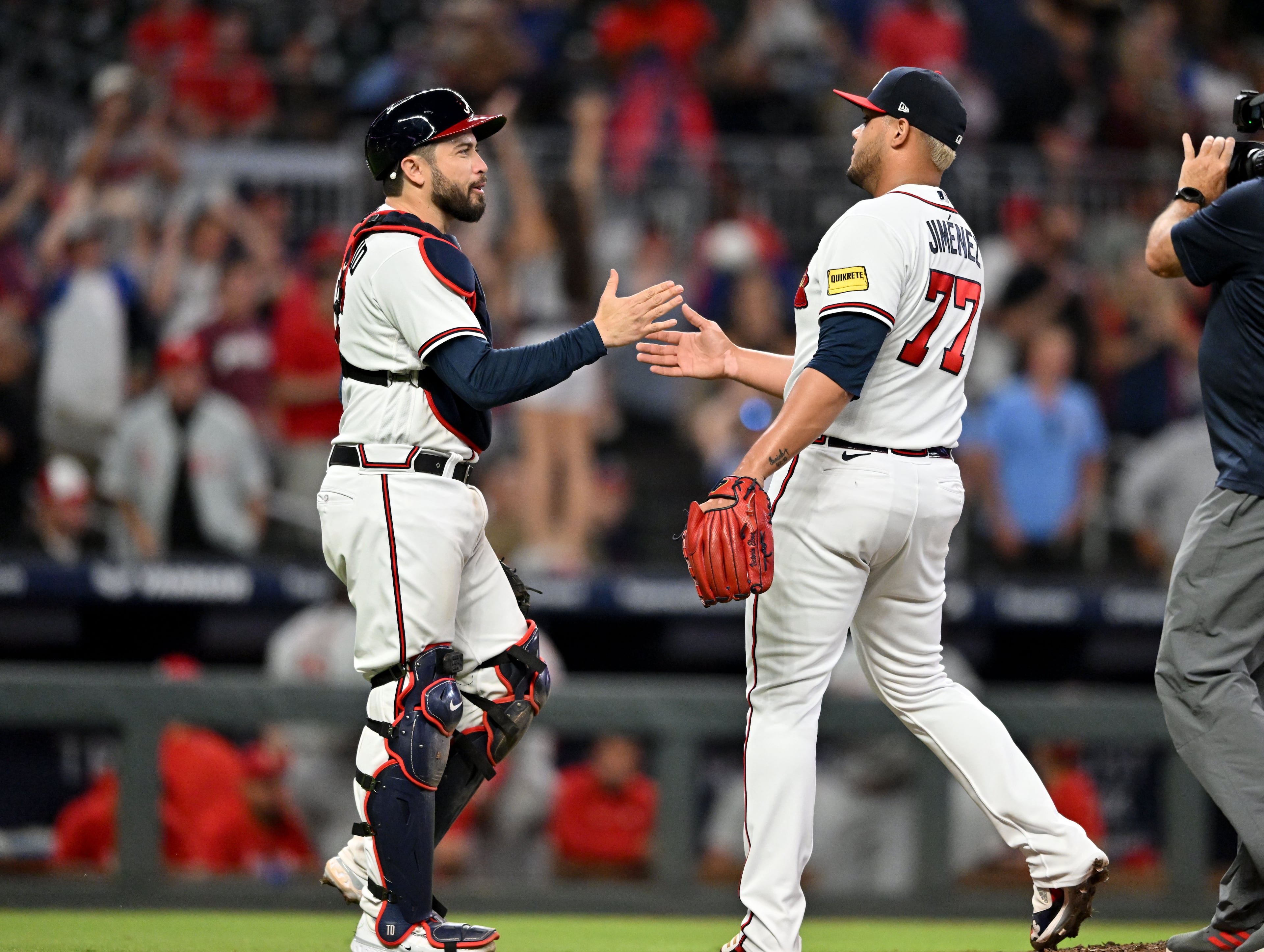 Braves catcher Travis d'Arnaud (16) and Atlanta pitcher Joe Jiménez (77) celebrate their win at the end of the ninth inning at Truist Park, Tuesday, September 19, 2023, in Atlanta. (Hyosub Shin / Hyosub.Shin@ajc.com)
