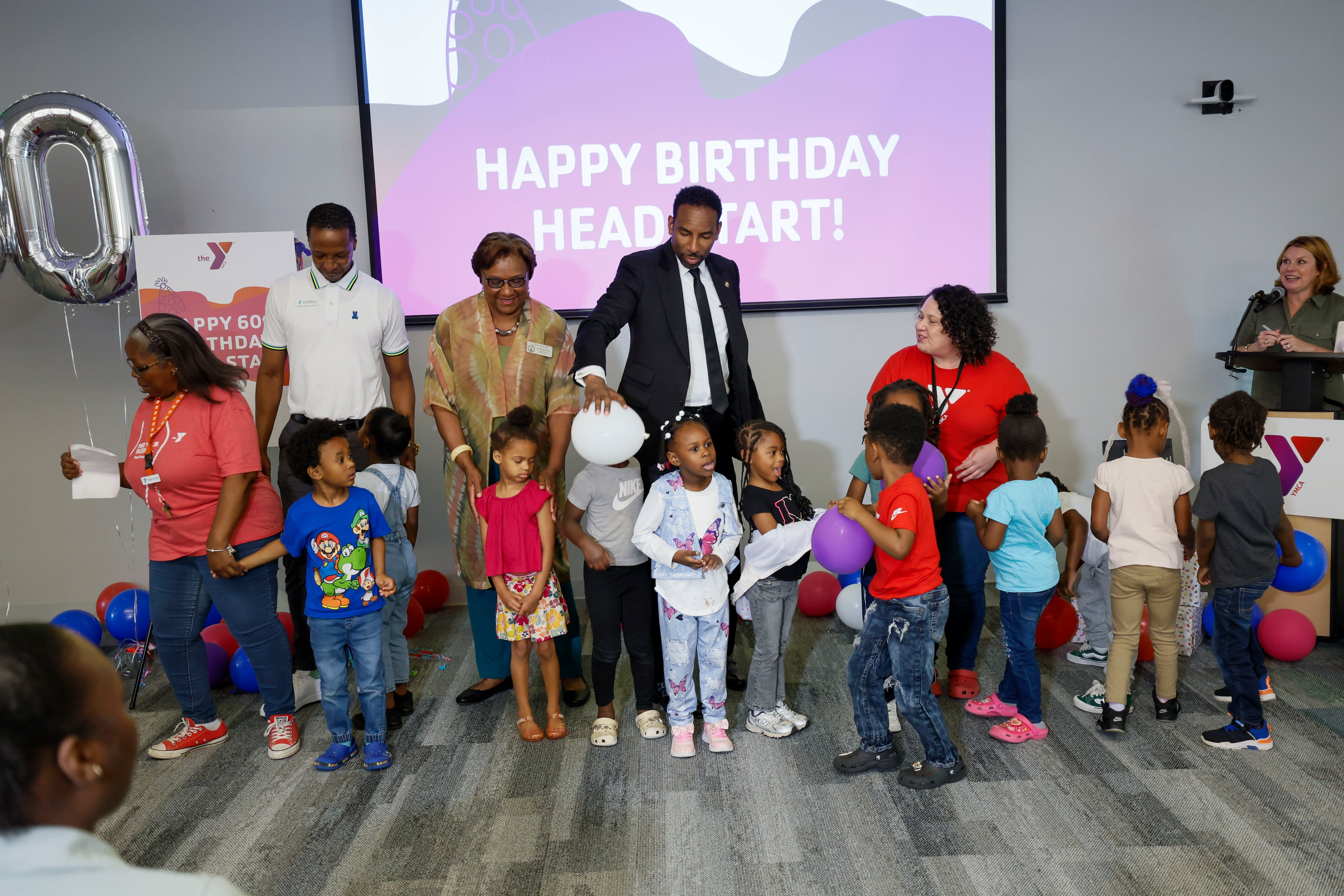 Atlanta Mayor Andre Dickens plays with early learners after they posed for a photograph during the 60th birthday celebration of the federal Head Start program at the Arthur M. Blank Early Learning Center on Monday. (Miguel Martinez/AJC)