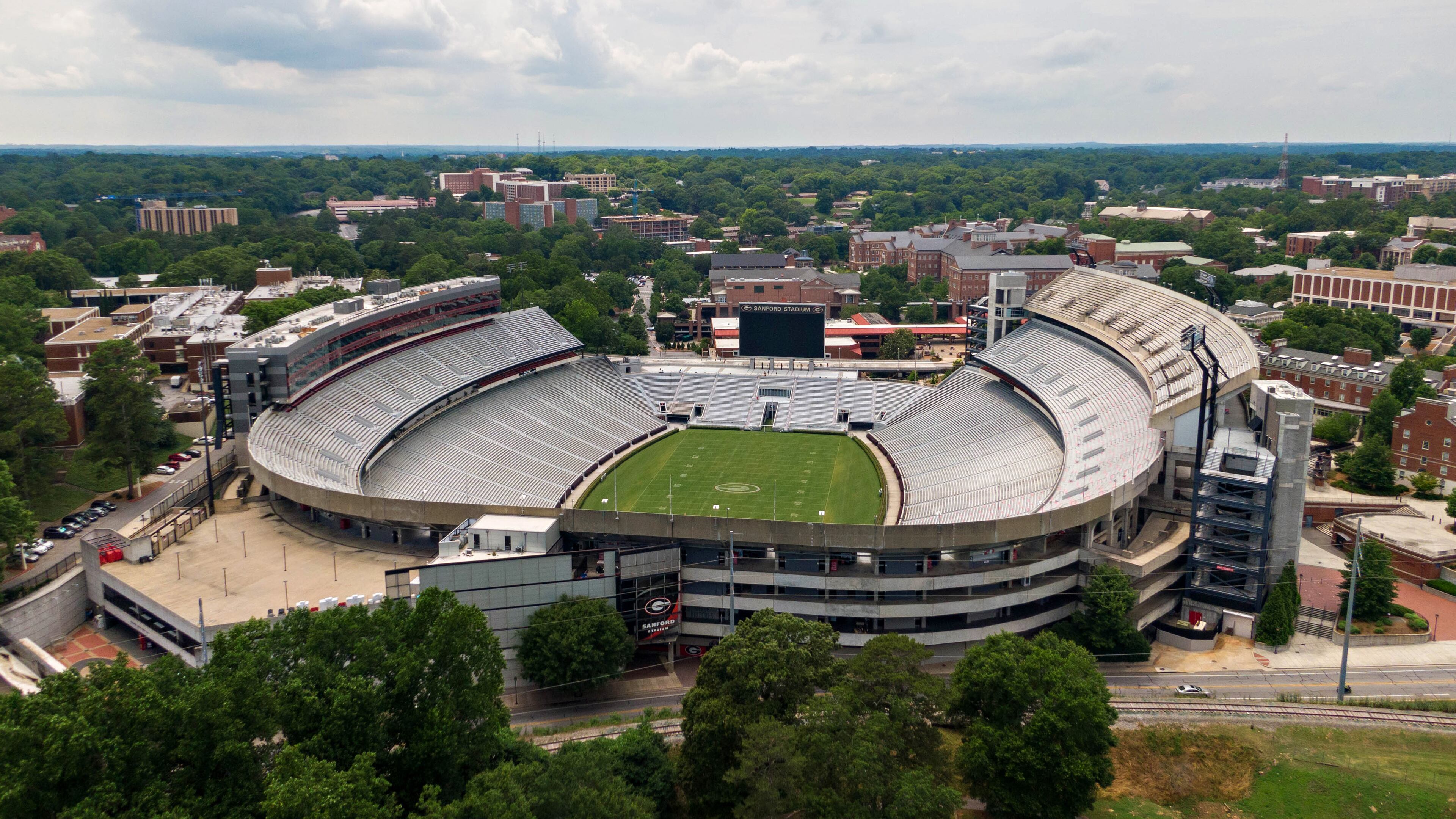June 11, 2021 Athens - Aerial photo shows Sanford Stadium at the University of Georgia in Athens on Friday, June 11, 2021. With a $25 million expansion completed in 2003 and another $8 million in 2004, Sanford Stadium added a second upper deck on the north side and 27 new north side SkySuites bringing the new stadium capacity to 92,746Ñthe fifth largest on-campus stadium in the country. UGAÕs athletic department simply is committed to too many other facility projects that have precedence at the moment. Most notable is the $80 million football operations building that has been added to the Butts-Mehre complex. (Hyosub Shin / Hyosub.Shin@ajc.com)