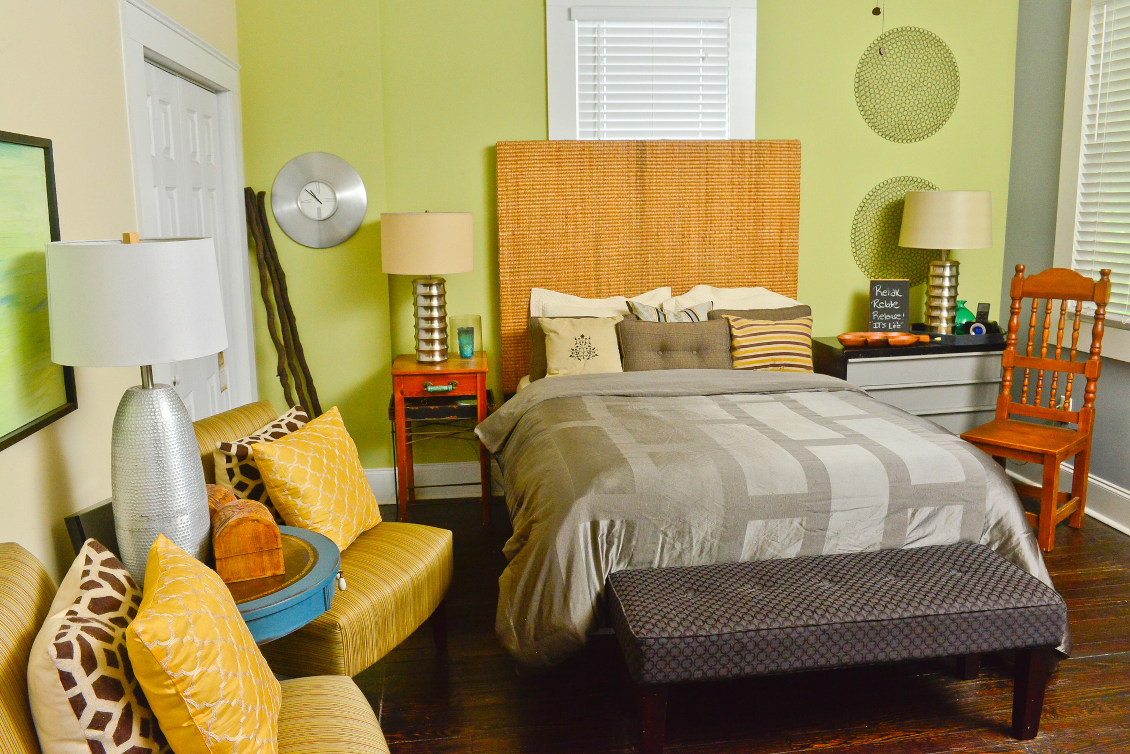 Sherwin-Williams Hearts of Palm meets Sherwin-Williams Fog Grey in the guest bedroom. The homeowners' personal preferences inspired the paint palette, as well as the modern eclectic interior design style they have created. "We do a lot of shopping on the weekends," says McNeal. "We just kind of stop by Home Depot, Lowe's and Sherwin-Williams, and we just look at the colors."