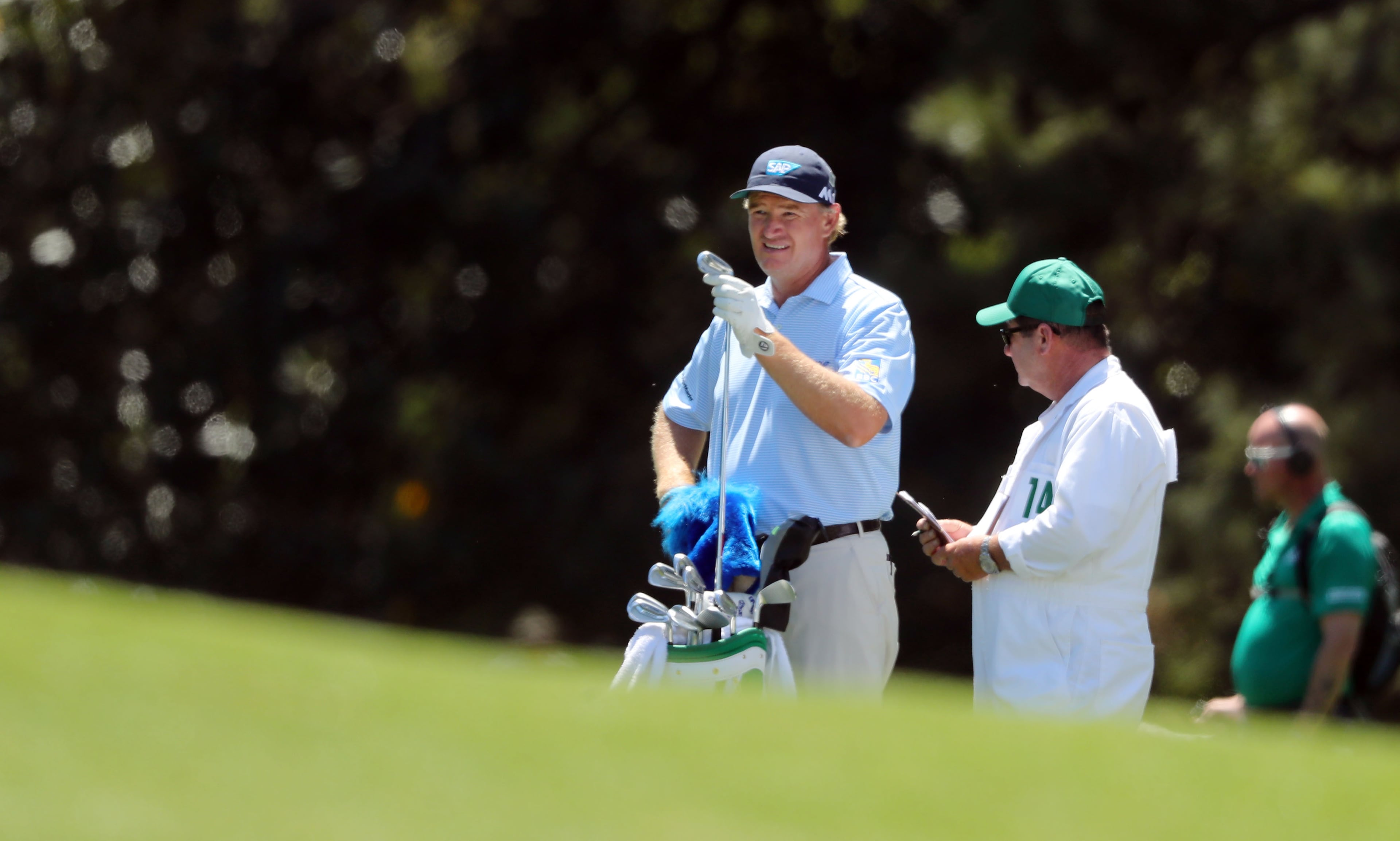 Ernie Els and his caddie, Ricci Roberts, await his shot on the 18th fairway.