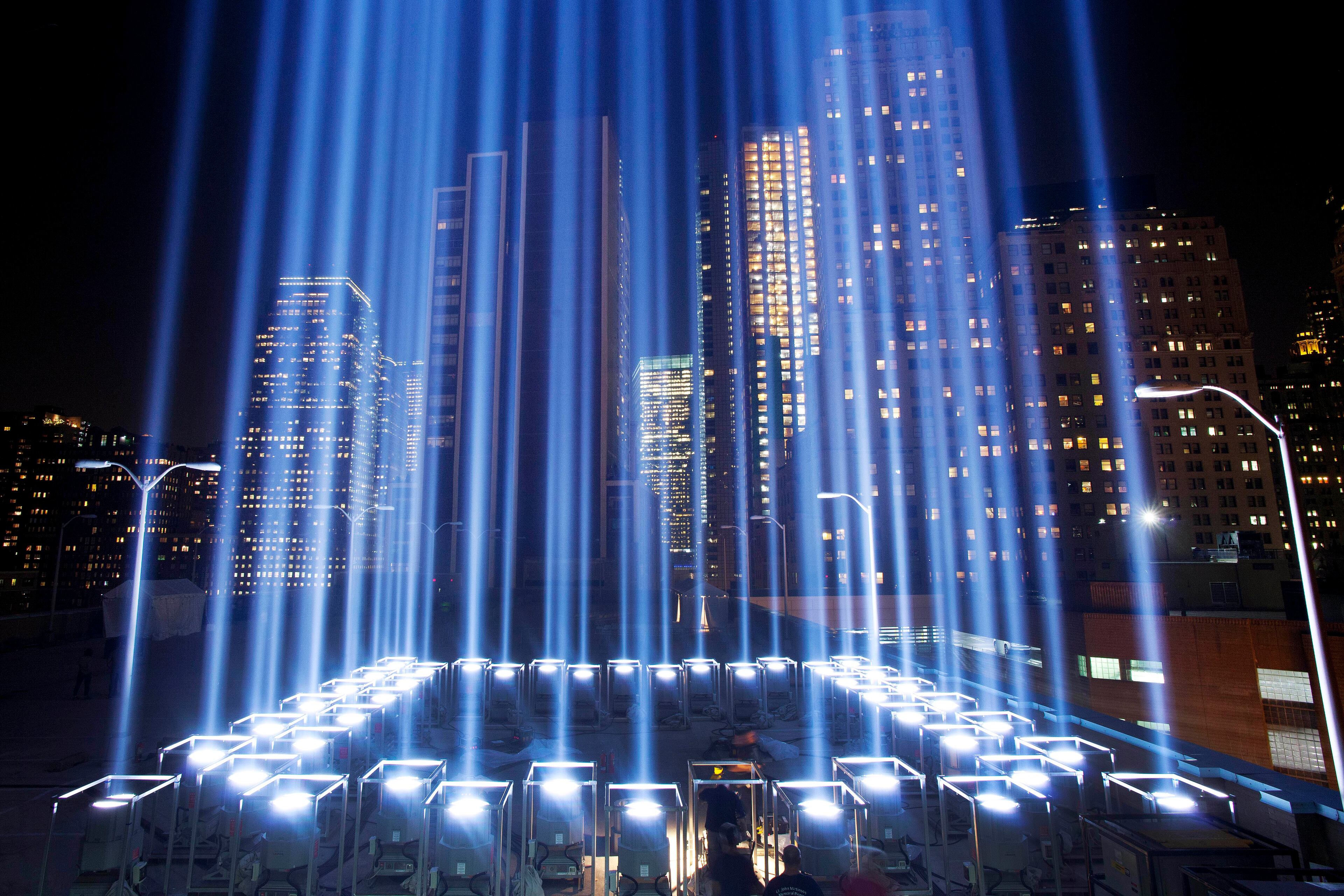 The Tribute in Light, rises above buildings in lower Manhattan, during a test, Tuesday, Sept. 10, 2013 in New York. The light display commemorates the twin towers of the World Trade Center that were destroyed in terrorist attacks 12 years ago on Sept. 11, 2001. (AP Photo/Mark Lennihan)