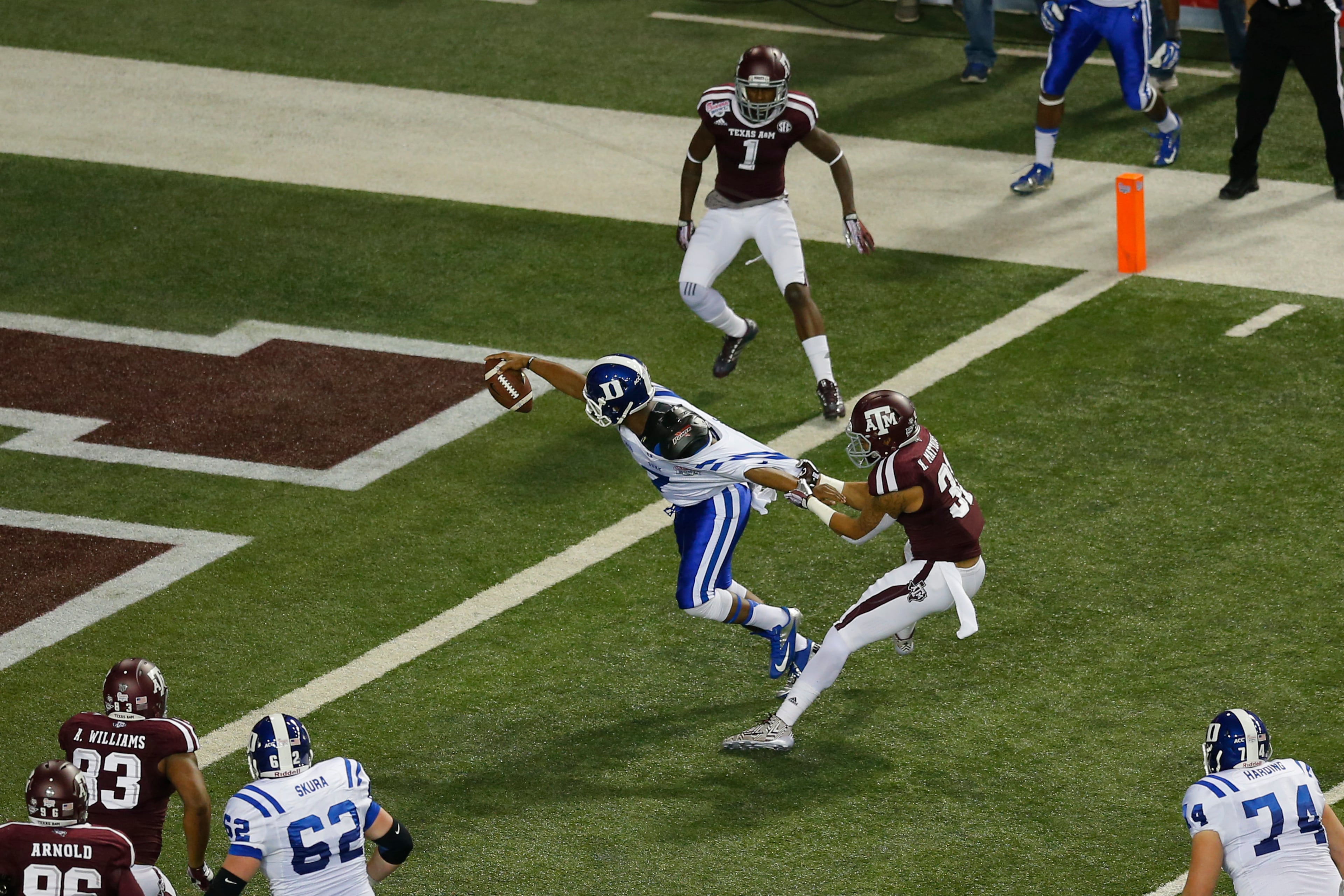 Duke Blue Devils quarterback Anthony Boone (7) stretches for a touchdown against Texas A&M Aggies defensive back Howard Matthews (31) during the 2013 Chick-fil-A Bowl at the Georgia Dome.